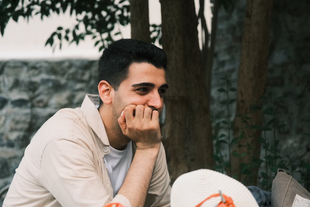 thoughtful-man-resting-outdoors-in-natural-setting