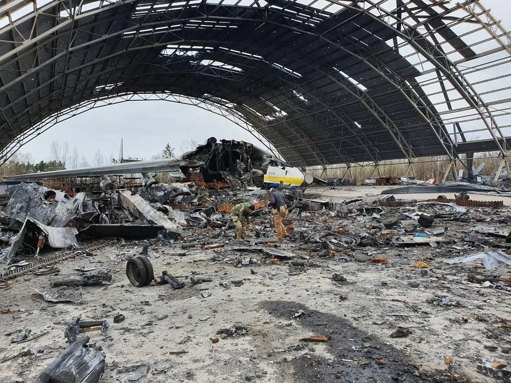 John+and+Dakota+clearing+unexploded+ordnance+in+front+of+the+destroyed+giant+Antonov+22