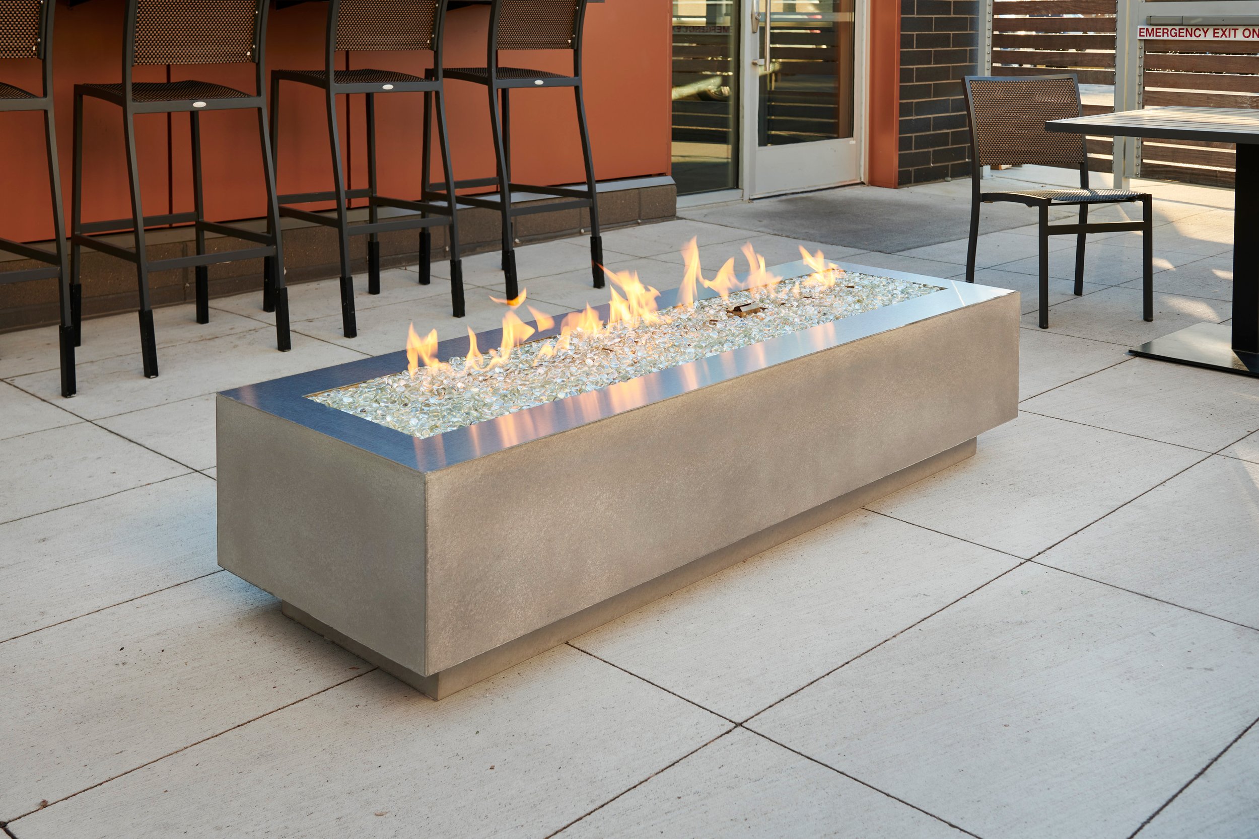 grey cove fire table with stainless steel trim on tile surface
