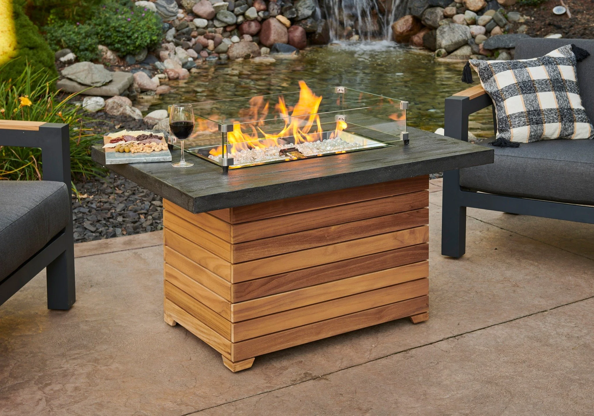 Right now save 30% on the Darien fire table! Give us a call today at 608-405-5596 to reserve yours!
A bit about this table: 
-Aluminum of Stone Grey Everblend concrete top
- Grade A teak wood base
-12”x42” Crystal Fire Plus burner
-Access