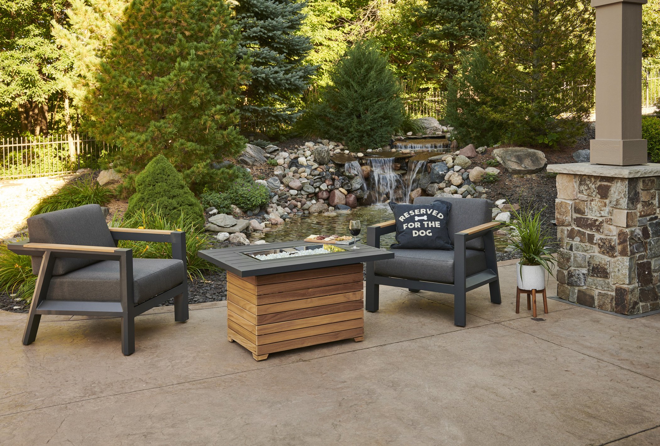 darien fire table with furniture in front of stone lined water feature
