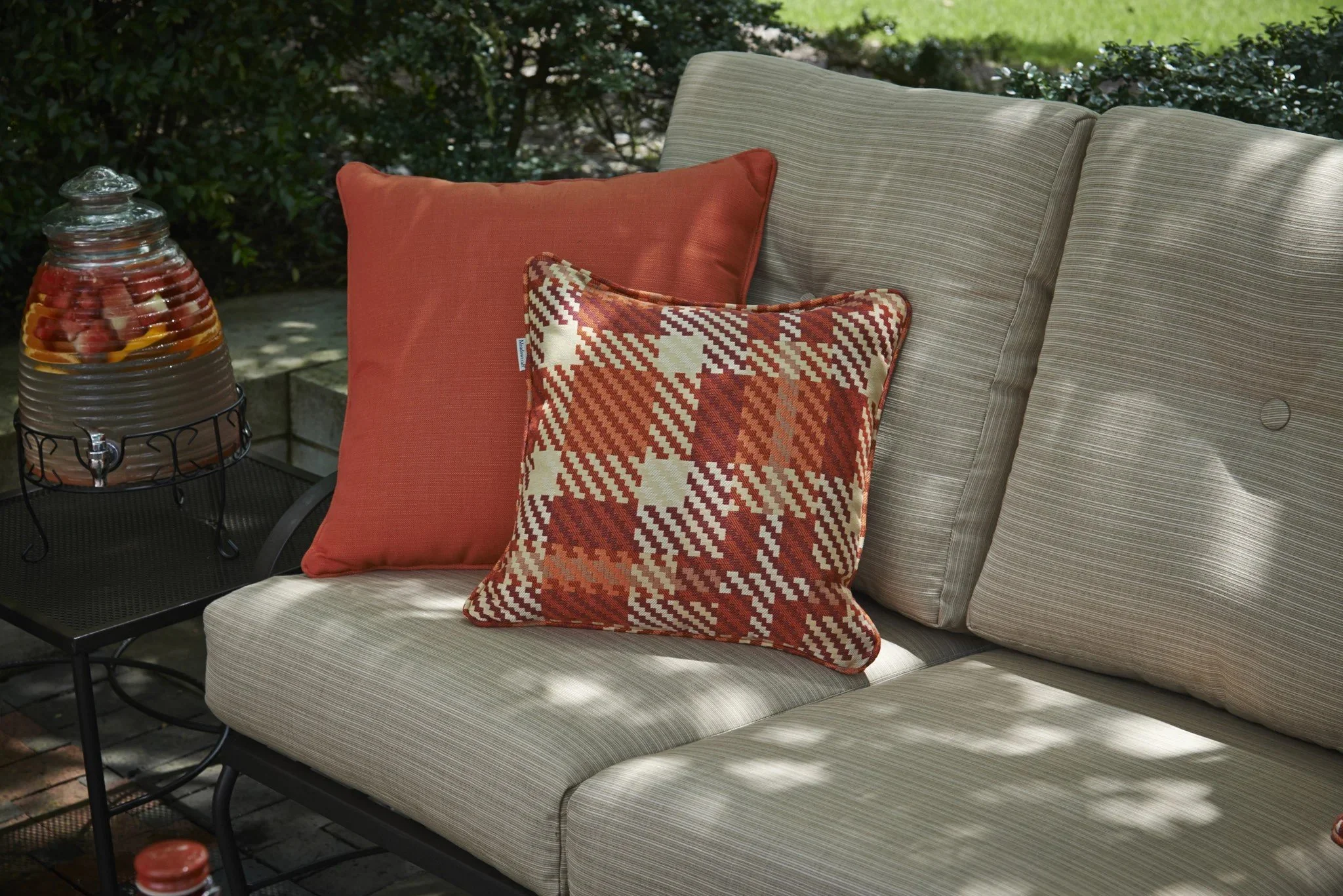 sofa with beige cushions and red throw pillows