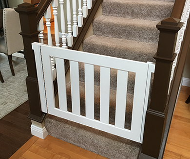 White safety gate at bottom of stairs