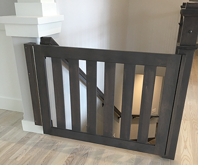 Safety gate at top of stairs in gray