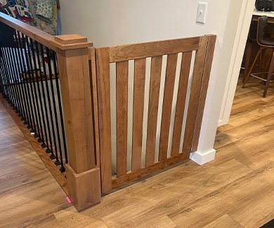 Stained wood custom home safety gate for stairs