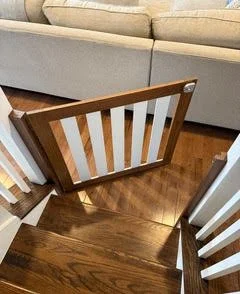 View of white and dark wood safety gate from upstairs
