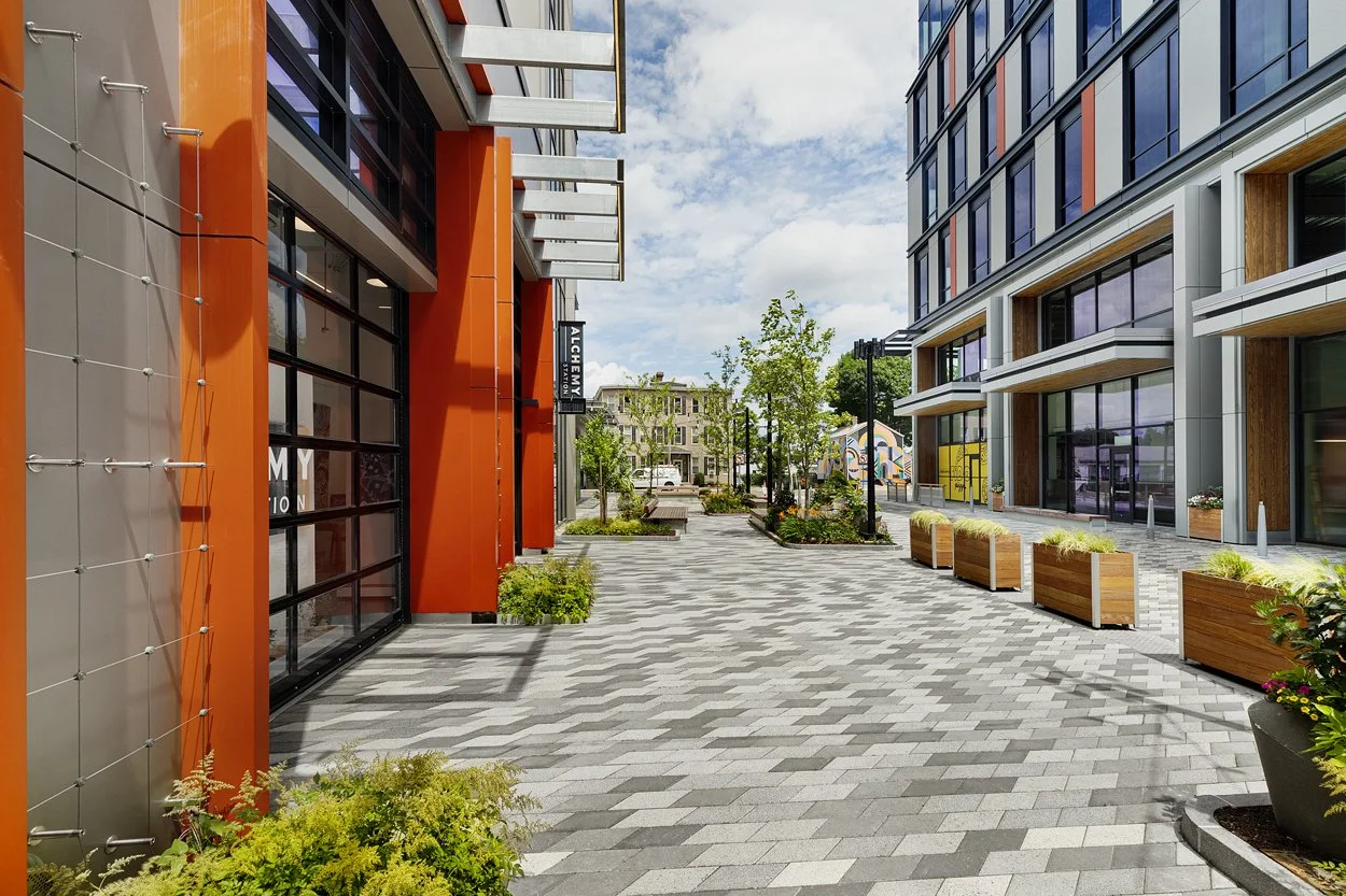 Open space plaza in Allston at the new Allston Labworks area with unique pavers various plant bed and planters.