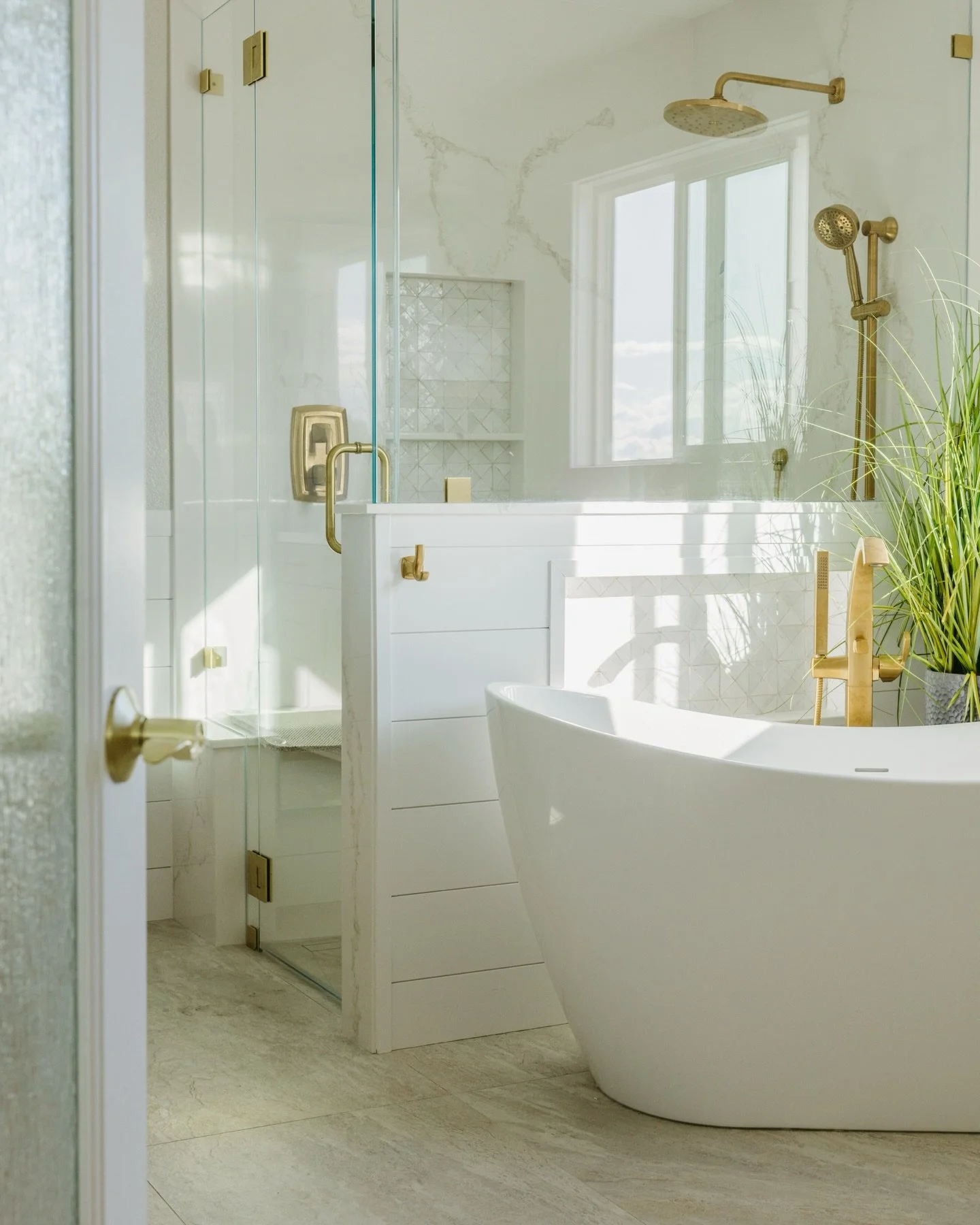 Light and airy with a touch of warmth for this Benicia bathroom! 

Light colors or whites with warm accents can provide the perfect balance for your bathroom. This one shows the perfect balance of both with the added towel cabinet, gold fixtures, and