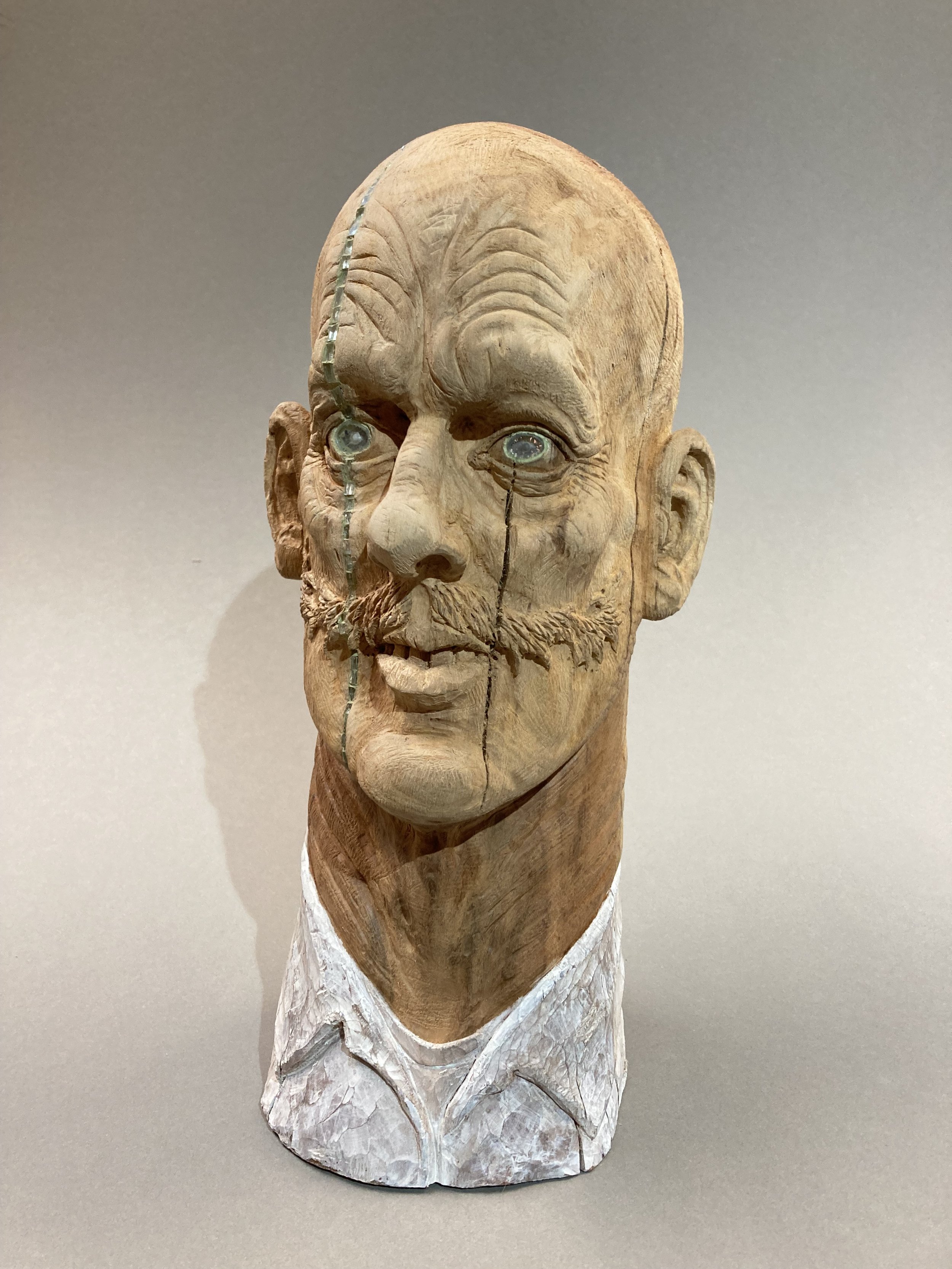 Hand carved sloe wood, glass and painted sculpture portrait of a man with moustache by Jason Thomson UK sculptor