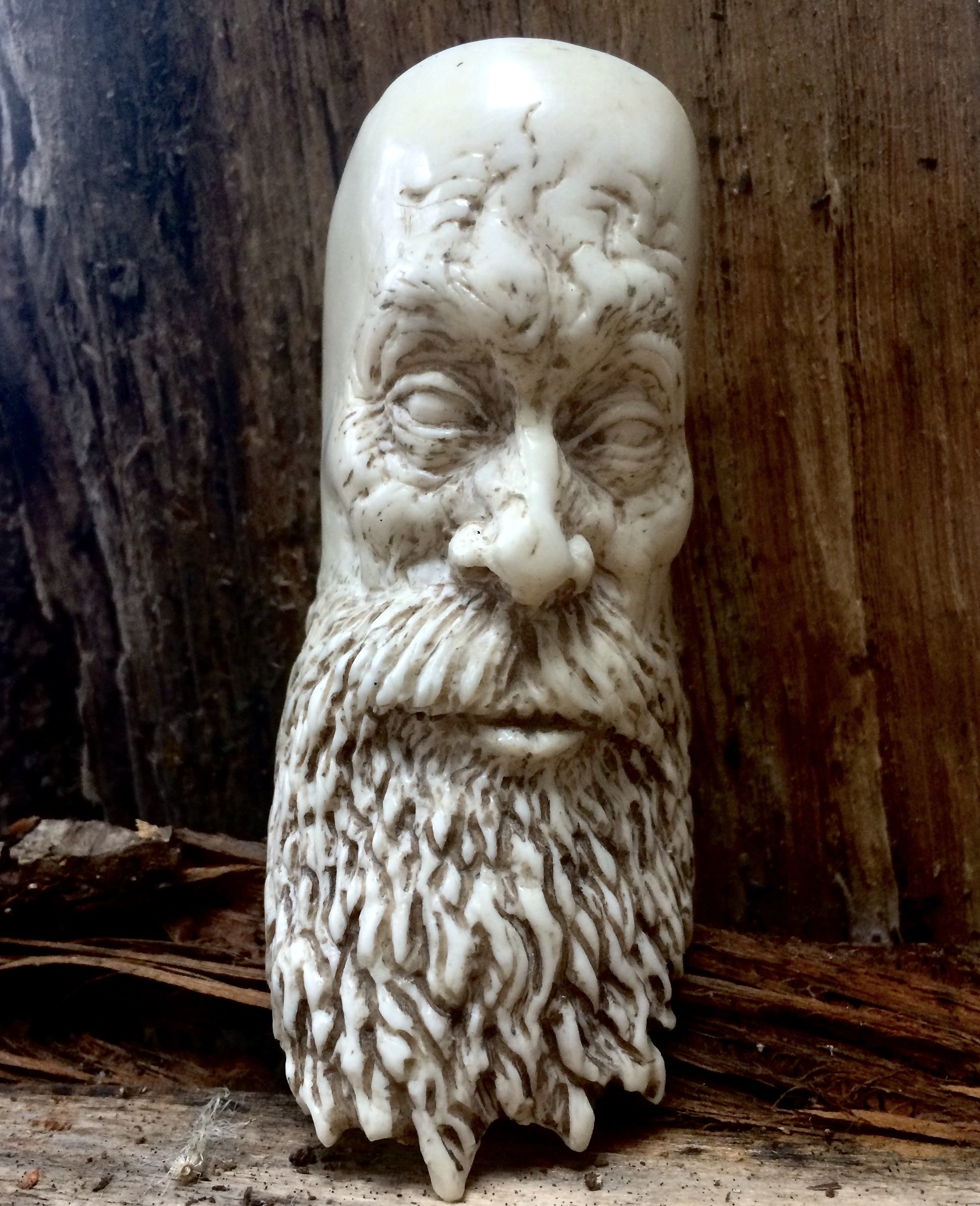 A miniature artwork hand carved bone bearded aged face by Jason Thomson