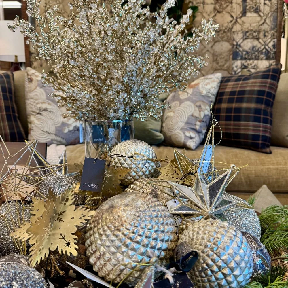 Christmas decorations featuring platinum tones, gold and brass finishes, glass accents, sequins, and antiqued mirrors.