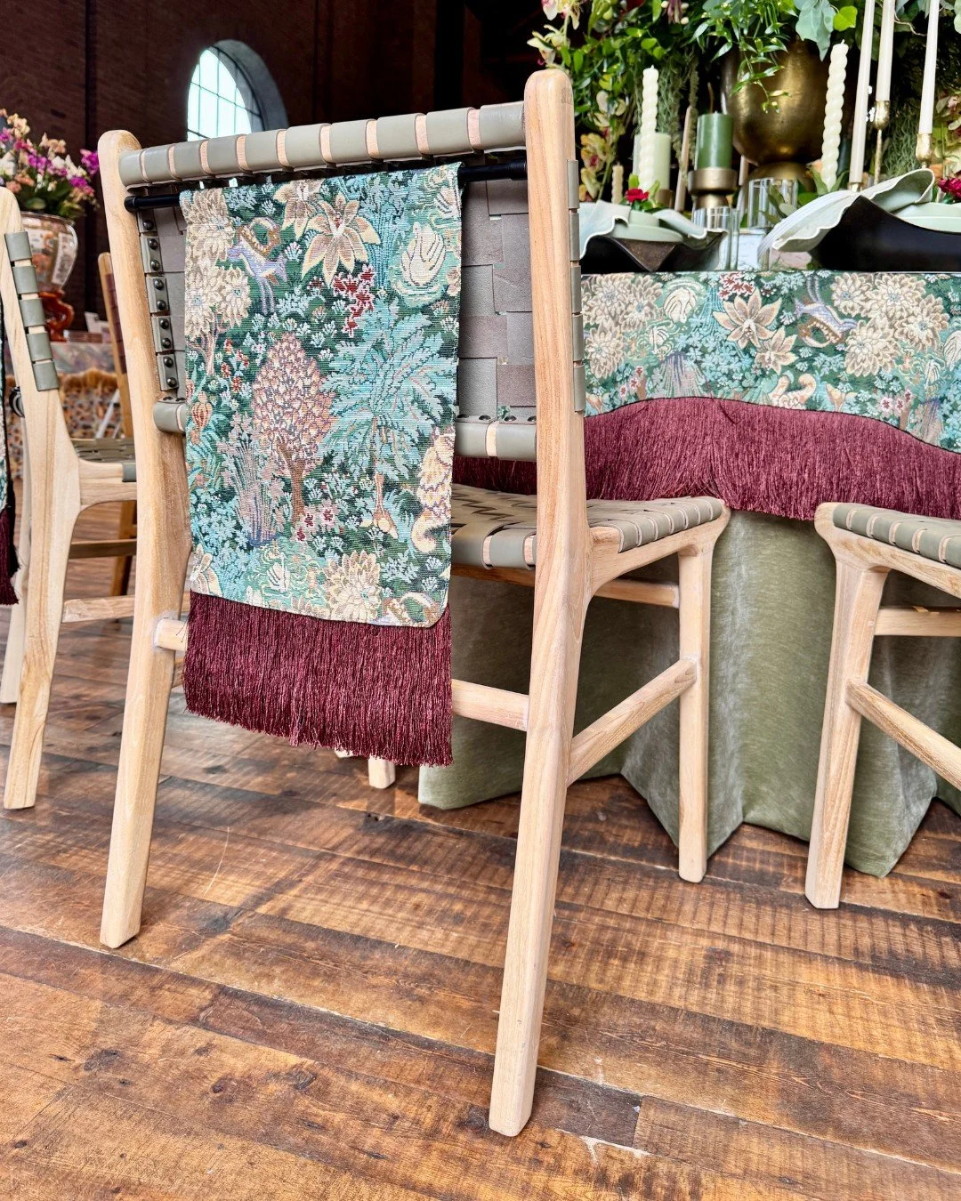 Close-up of a fabric chair pennant with tassel fringe detail in varying shades of green, fabricated by U-Fab Interiors.
