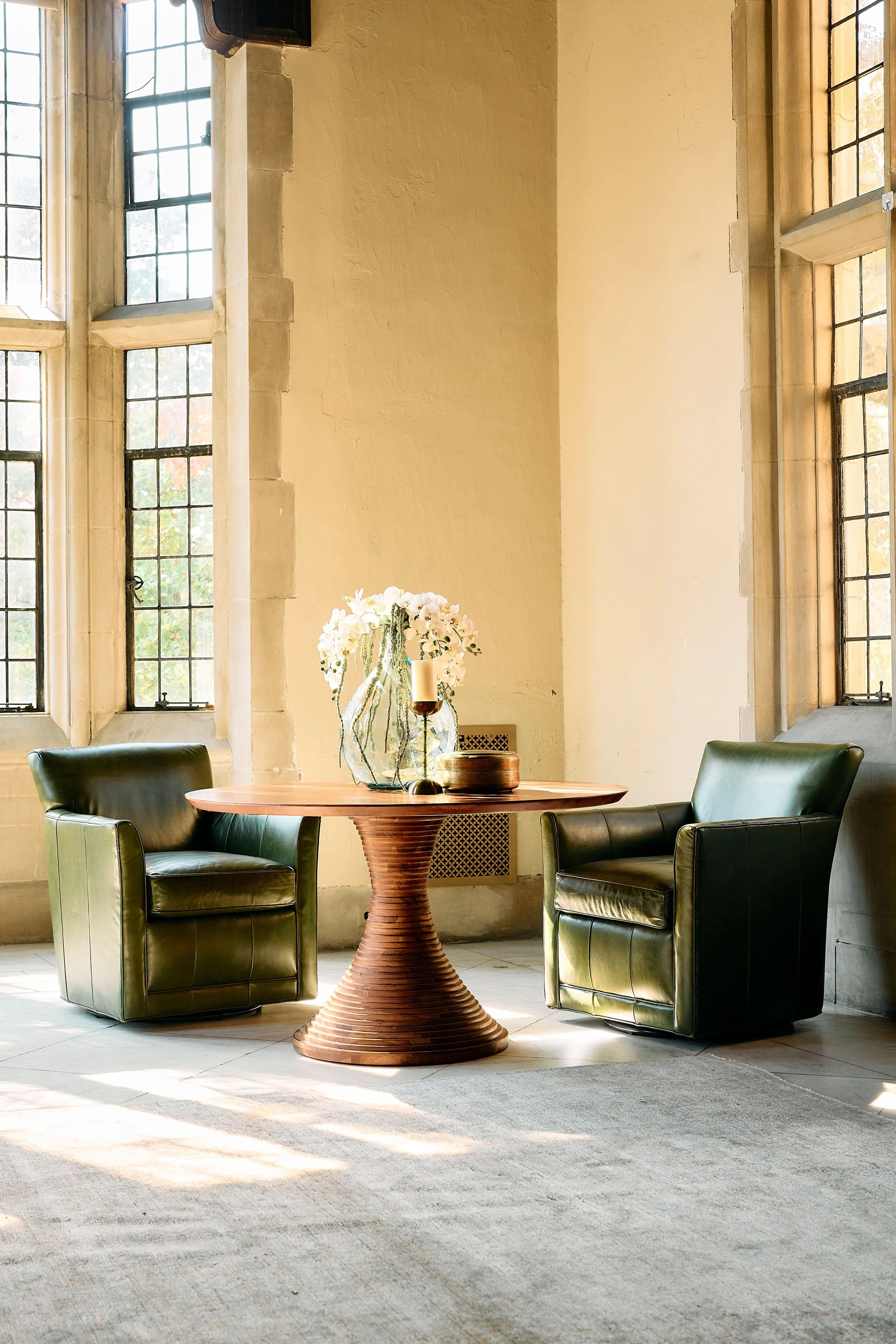 A dining room table and leather chairs styled at the Branch Museum in Richmond, Virginia.