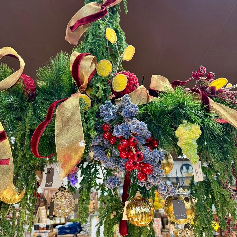 Traditional Christmas greenery decorated with fruit, vegetables, and floral accents inspired by classic holiday wreaths and garlands.