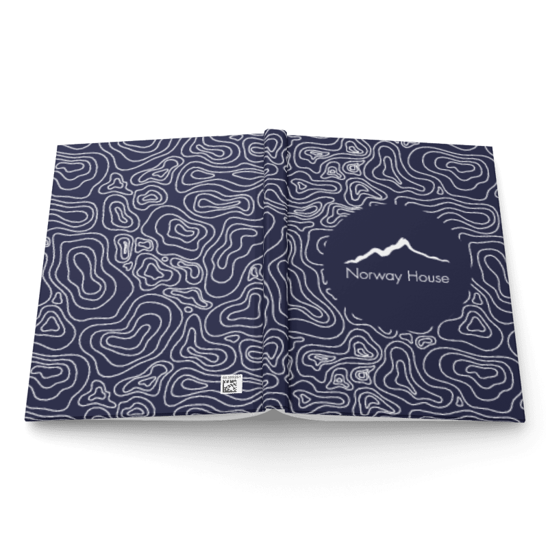 Open booklet or magazine with dark blue and white topographic map design and the logo 'Norway House' on the right page.