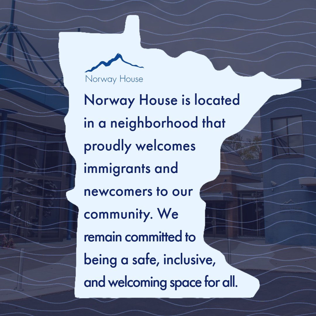 A sign in the shape of the state of Minnesota with text about Norway House welcoming immigrants and newcomers, emphasizing safety, inclusivity, and community.