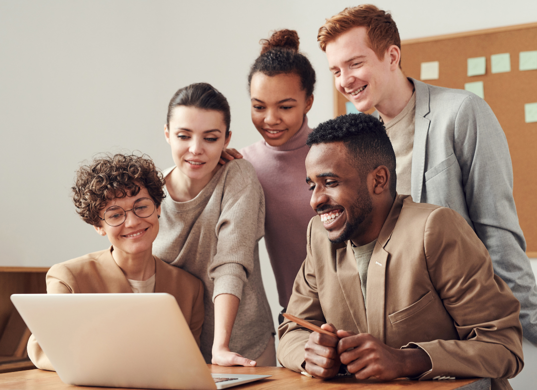 People Collaborating Looking at Laptop