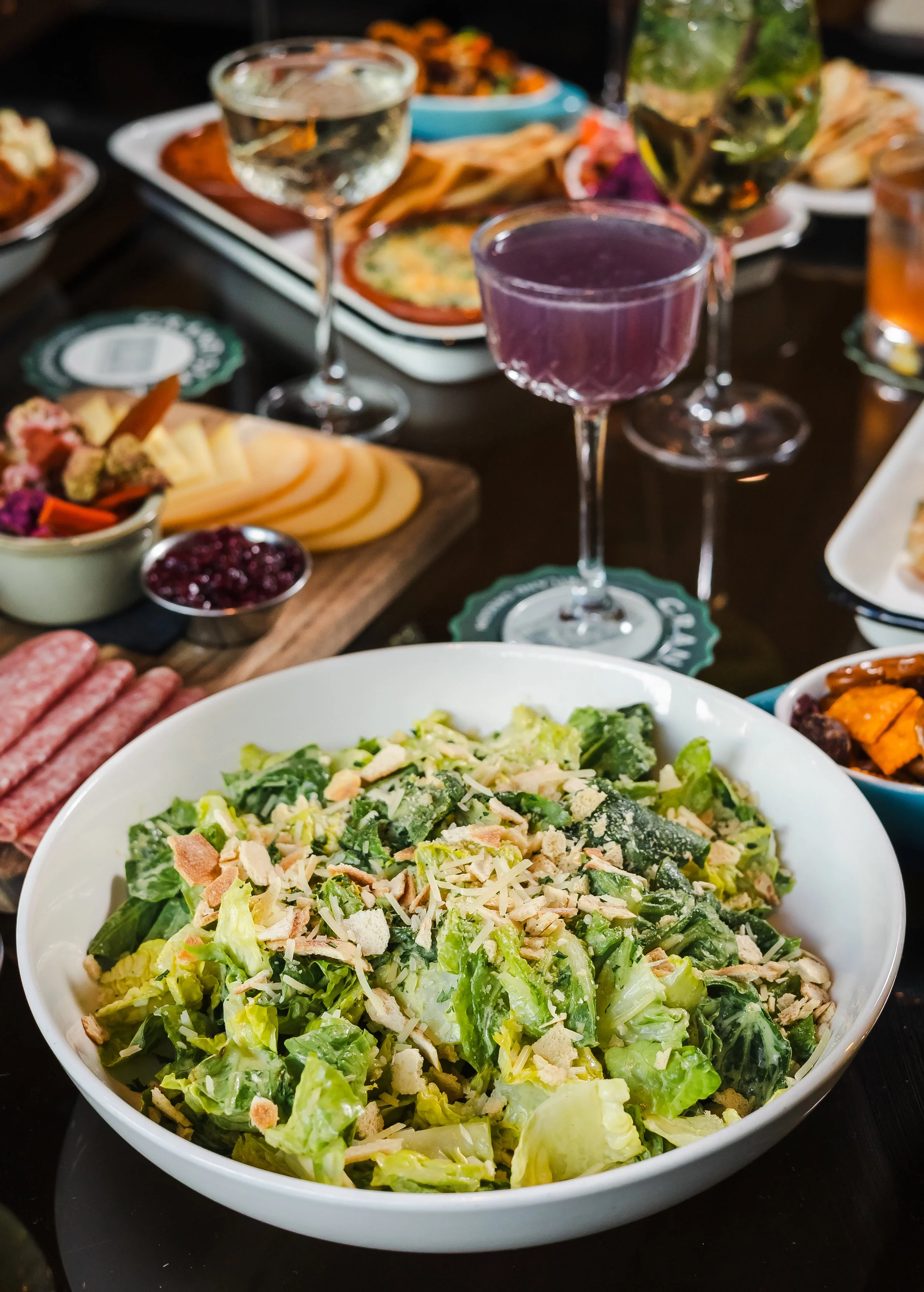A variety of dishes and drinks are laid out on a table.