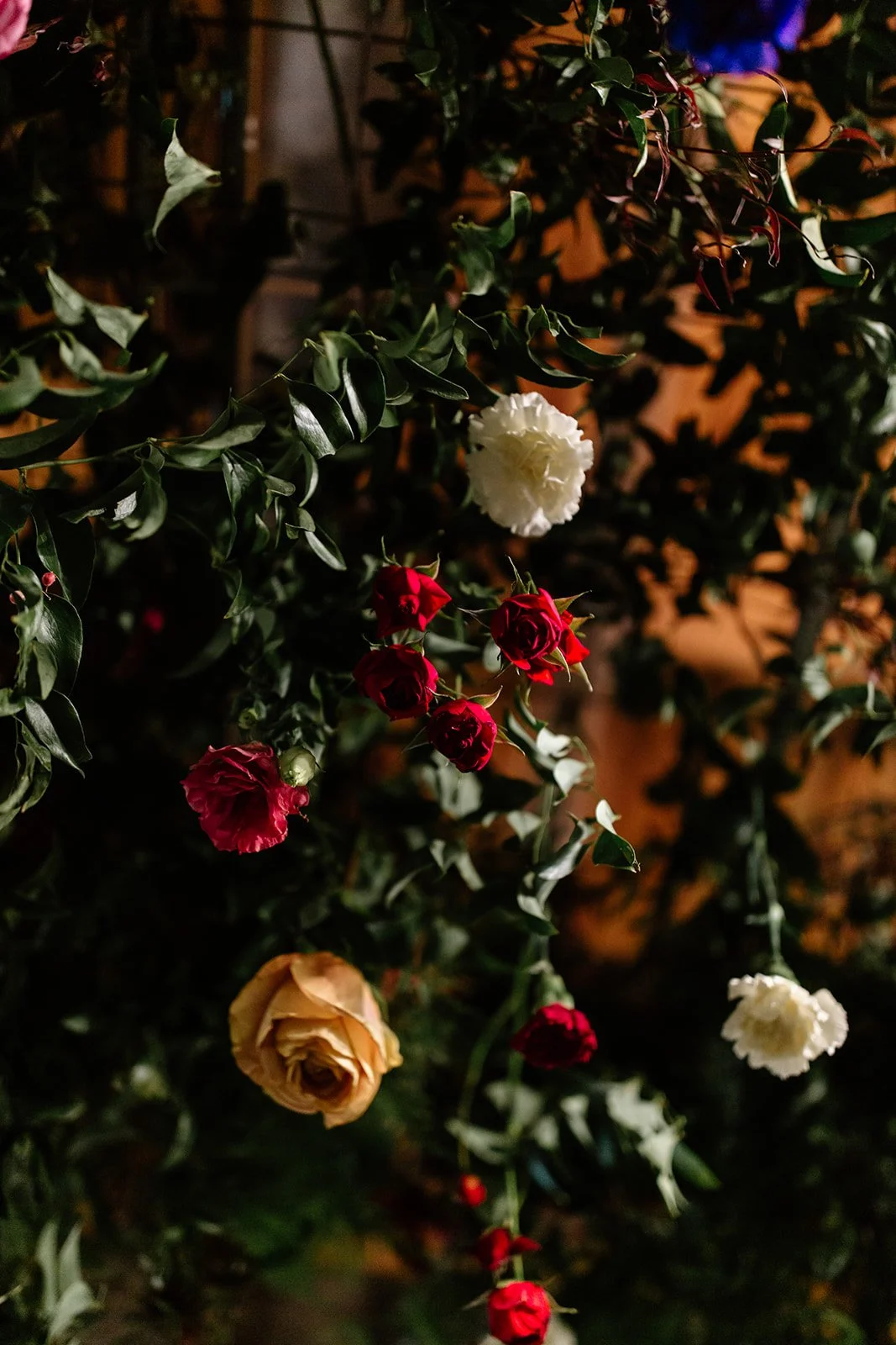 closeup of flower installation with greenery and roses