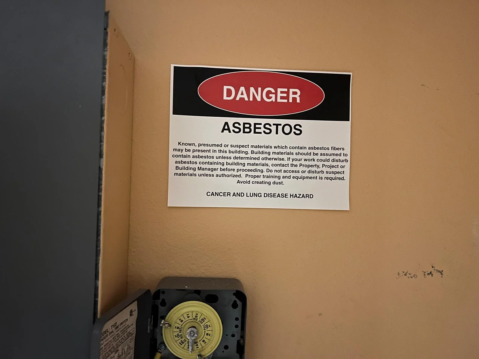 Danger Asbestos sign on wall