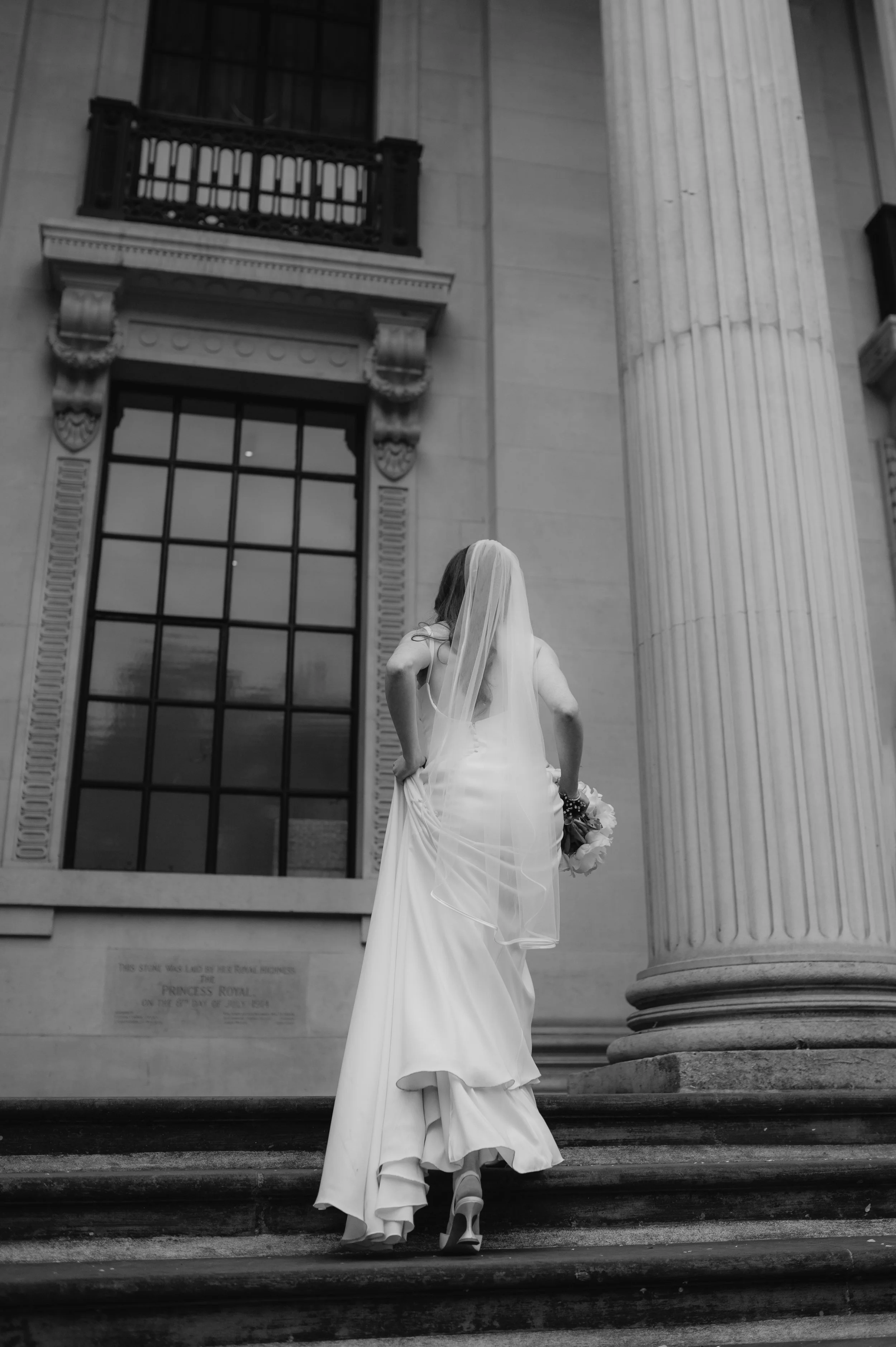 London wedding photography at Marylebone Town Hall bride walking up steps 