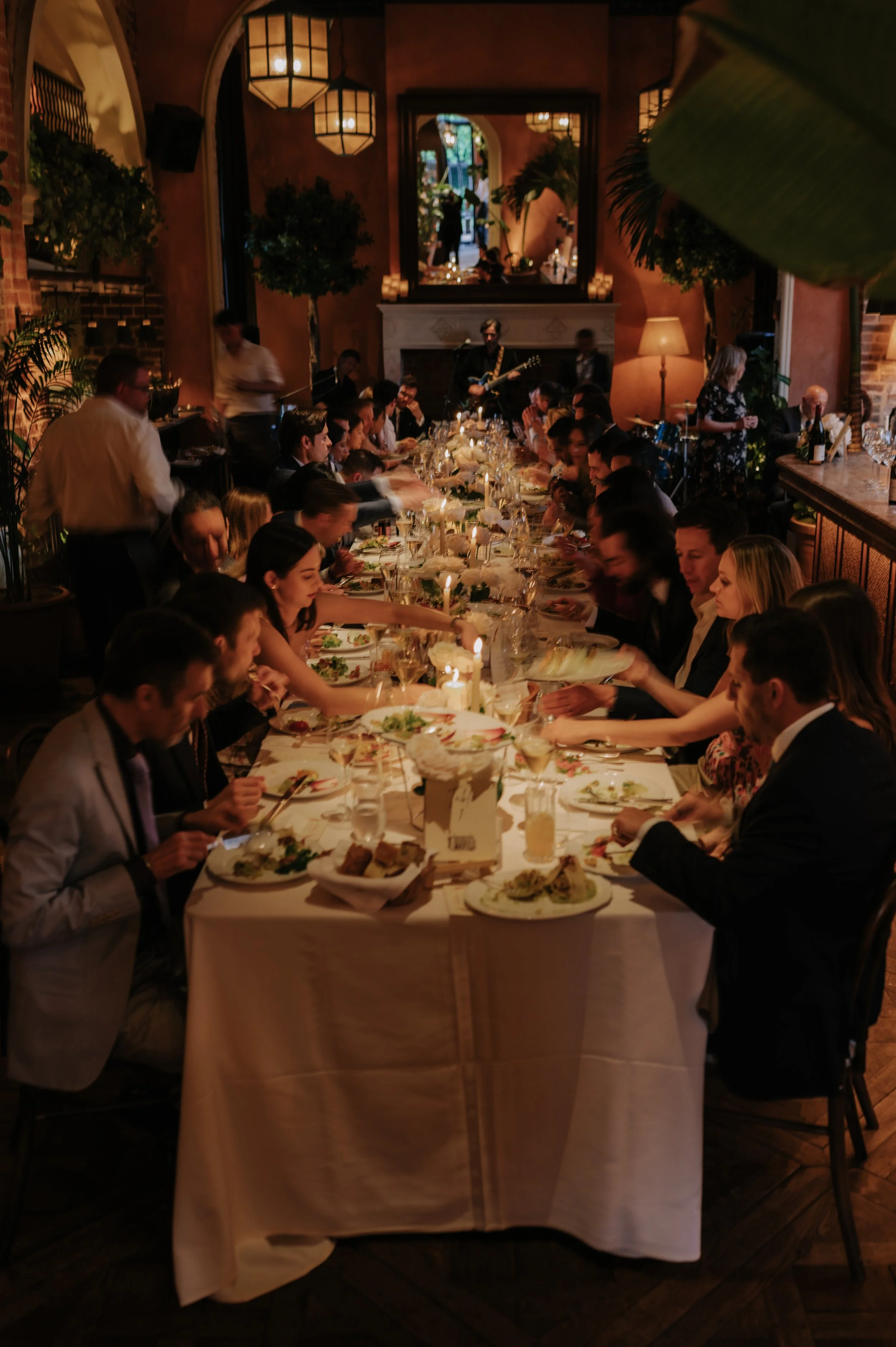 candlelit dinner London wedding photography at Belvedere in Holland Park guests sat at table sharing food 
