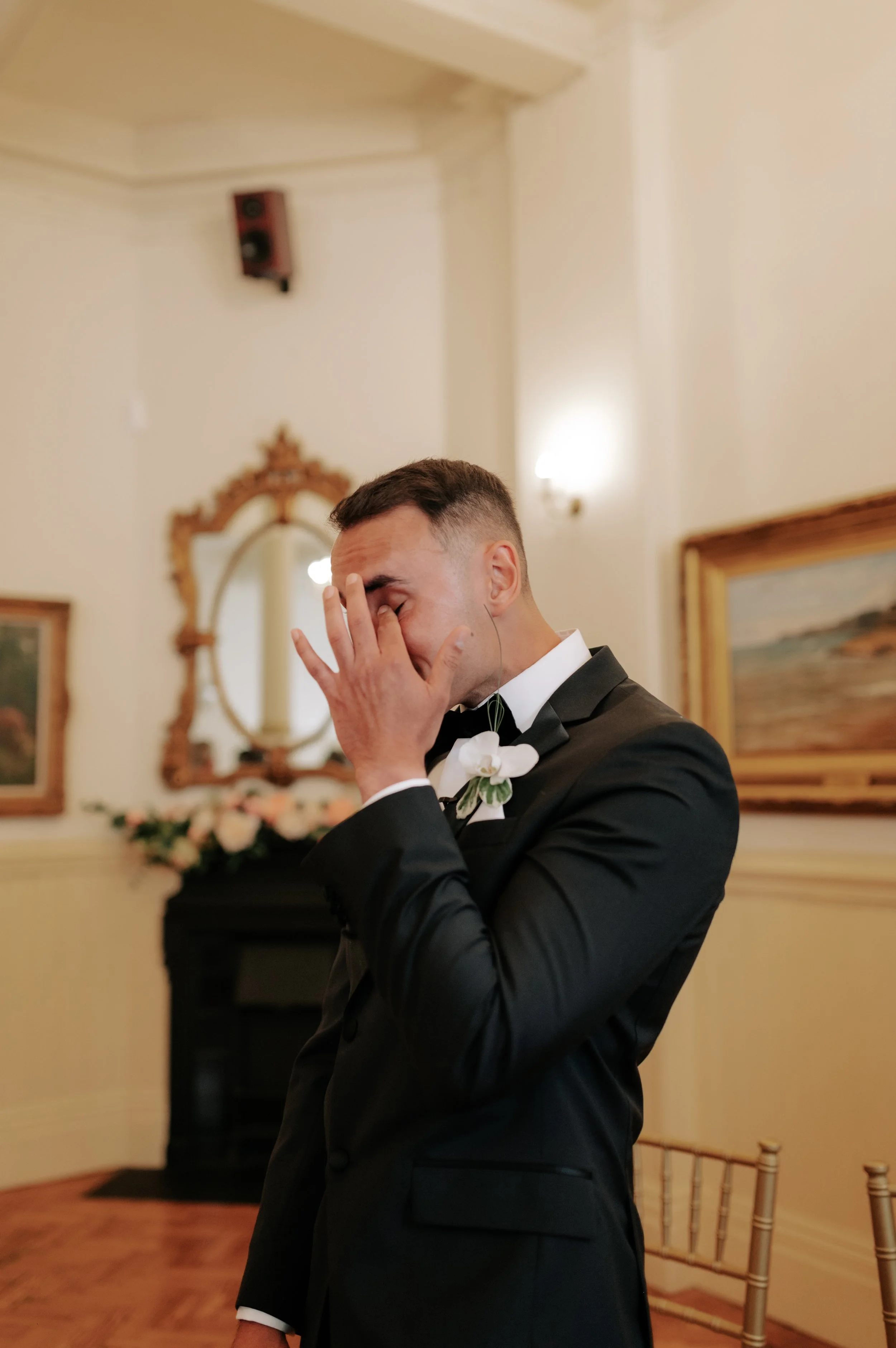 Groom wiping tear at Brighton wedding. Fine art documentary wedding photography. 