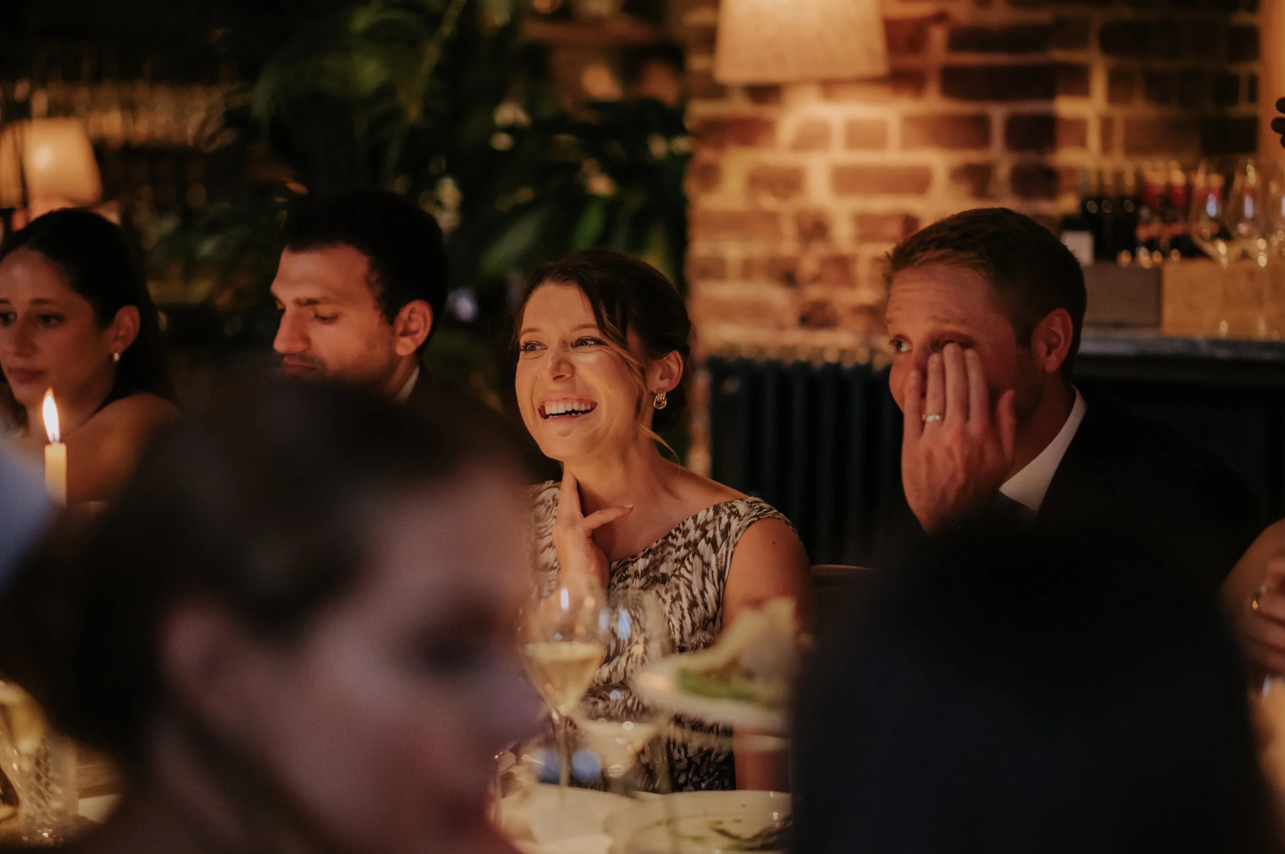 candlelit dinner London wedding photography at Belvedere in Holland Park guest laughing 