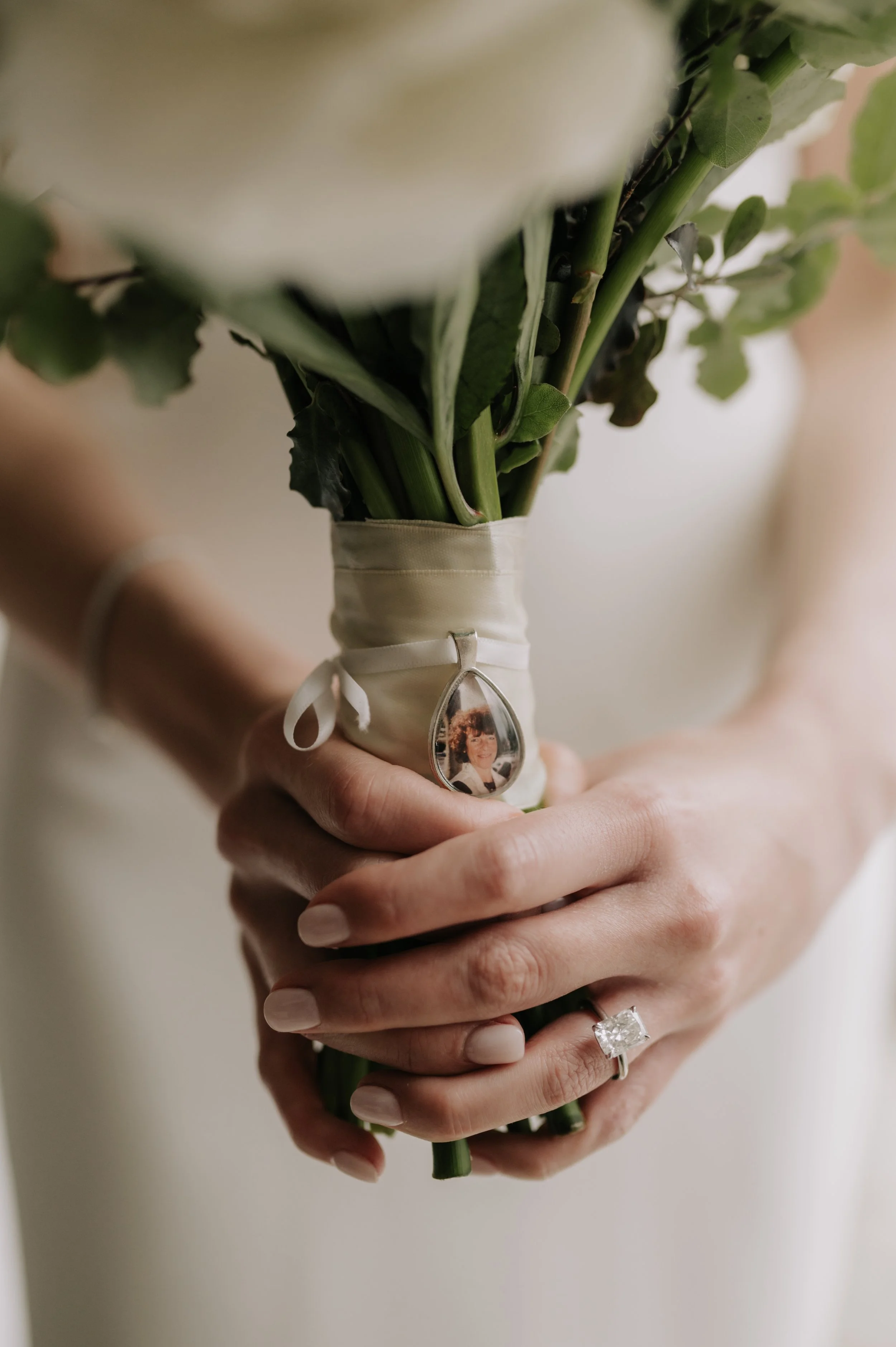 London wedding photography at Marylebone Town Hall photo of mum tied onto bouquet 
