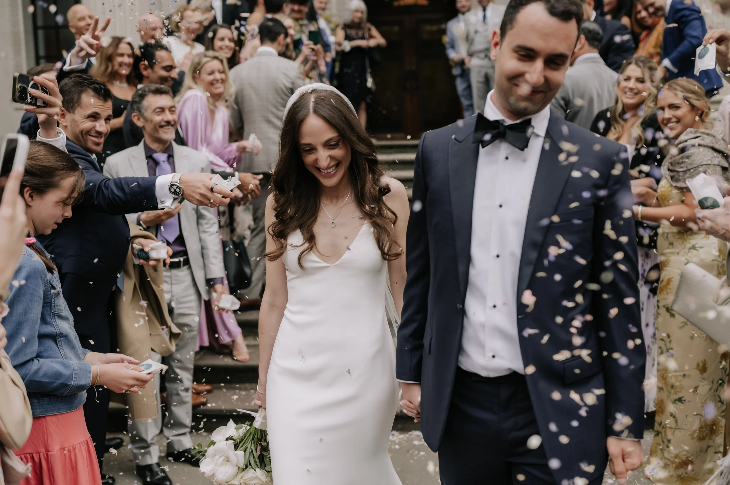 London wedding photography at Marylebone Town Hall bride and groom in confetti tunnel