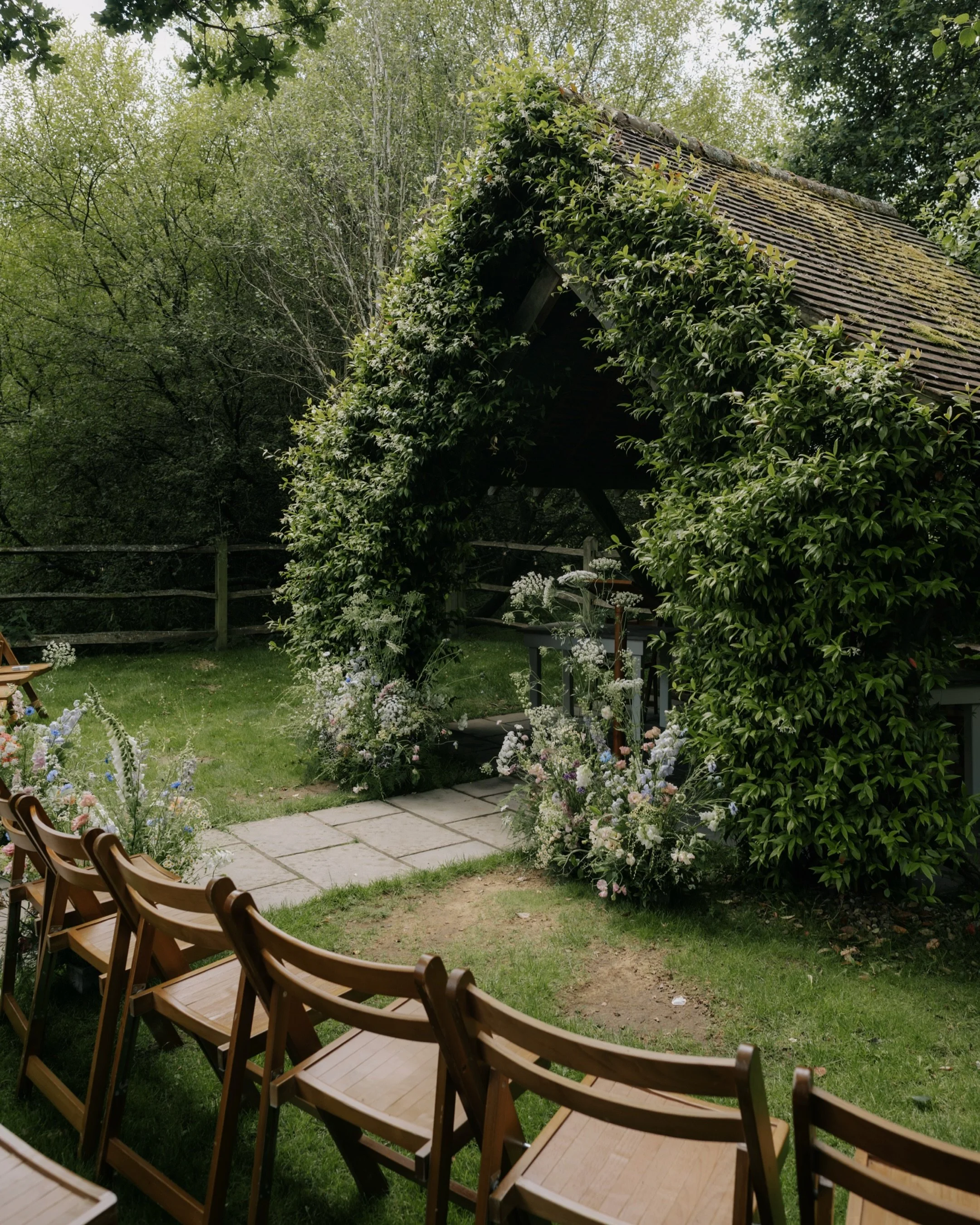 A ceremony amongst the greenery and flowers at @millbridgecourt 

Beautifully created by @madewithgracefloraldesign 

Video - @nmfilms__ 
Dress - @suzanneneville from @thedressteddington 
Jewellery - @caratlondon 
MUA &amp; Hair - @rosiehartstylist 
