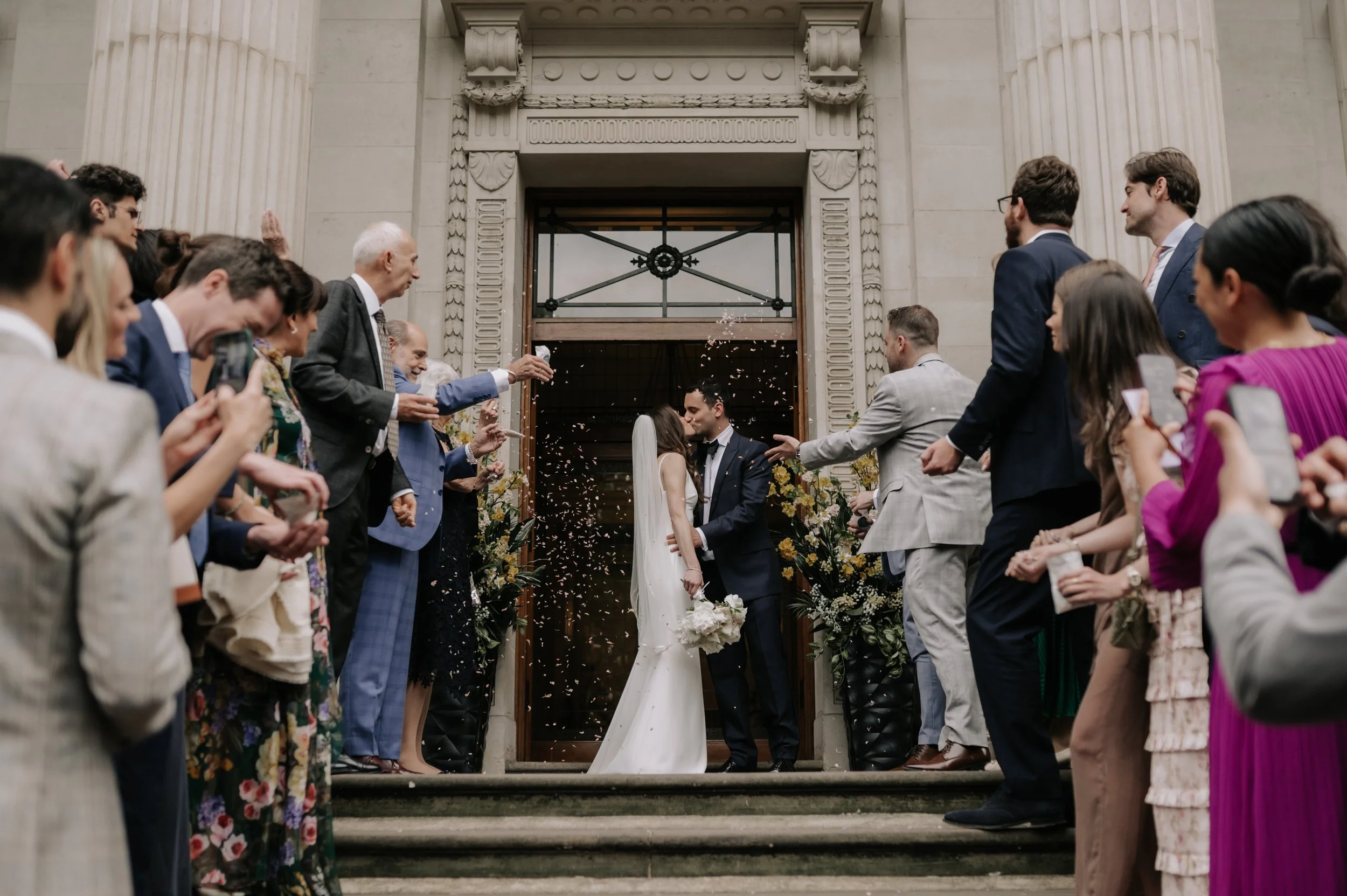 London wedding photography at Marylebone Town Hall bride and groom in confetti tunnel