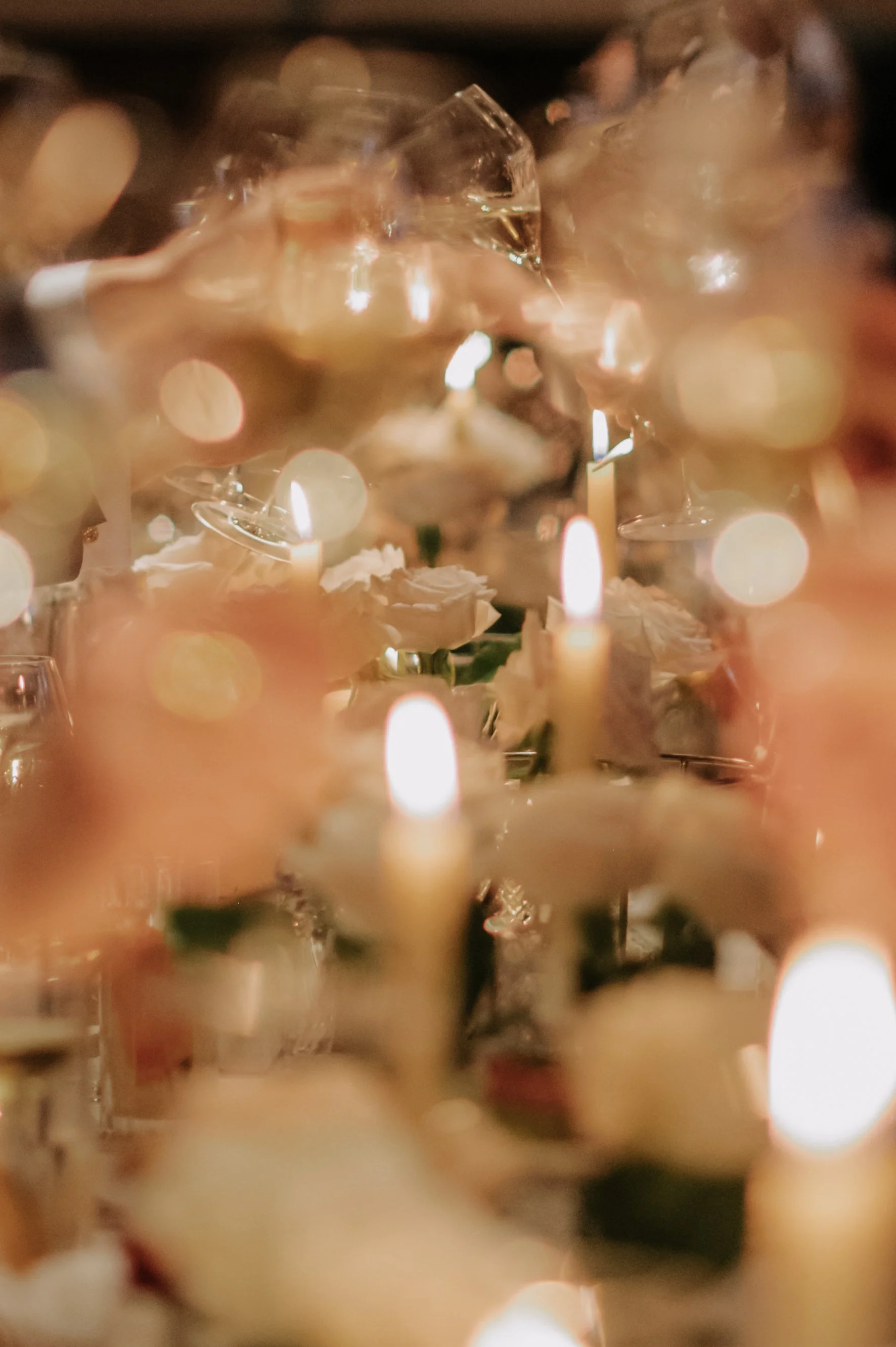 candlelit dinner London wedding photography at Belvedere in Holland Park blurred shot of glasses and candles 