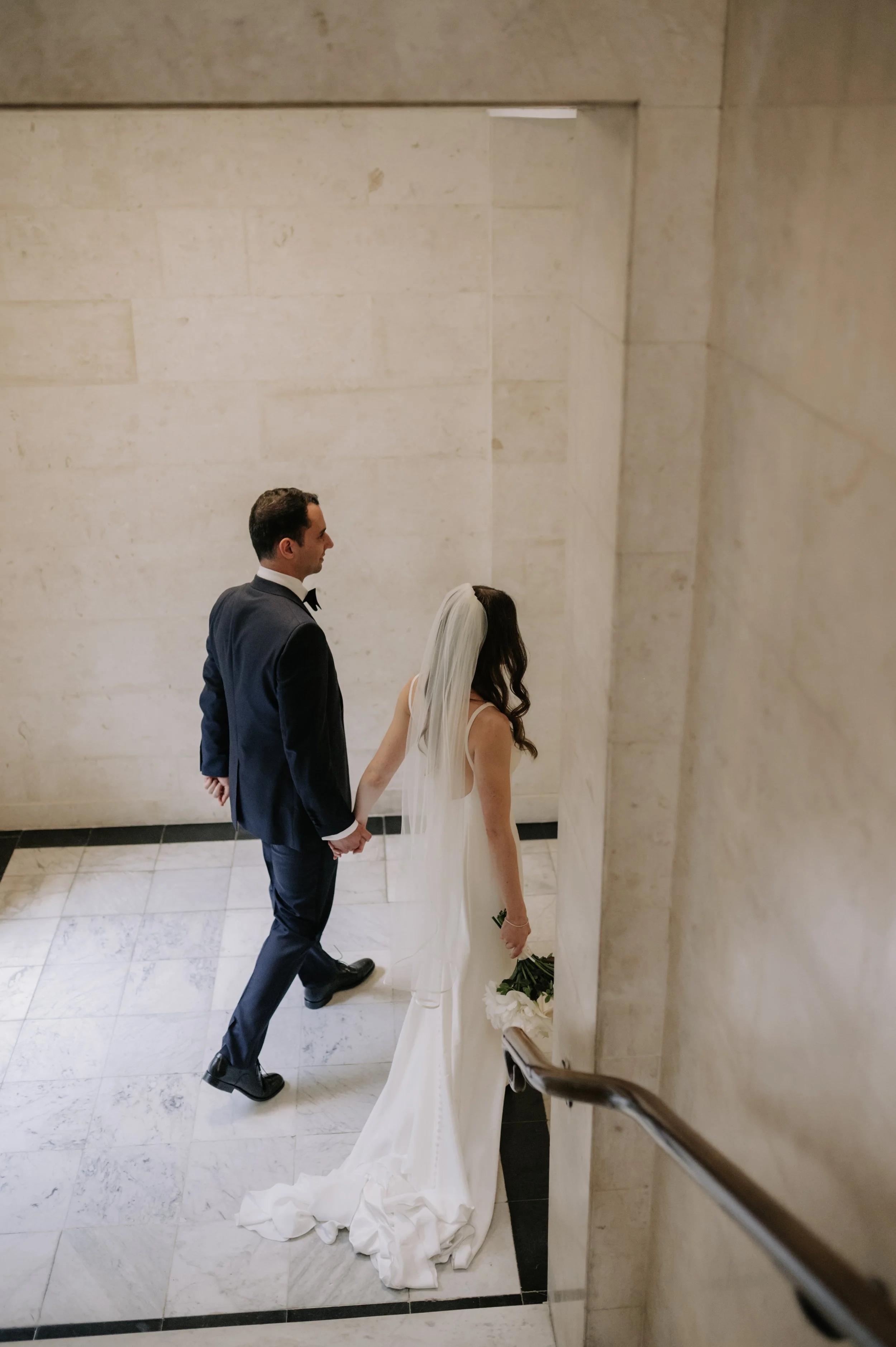 London wedding photography at Marylebone Town Hall bride and groom walking away from camera