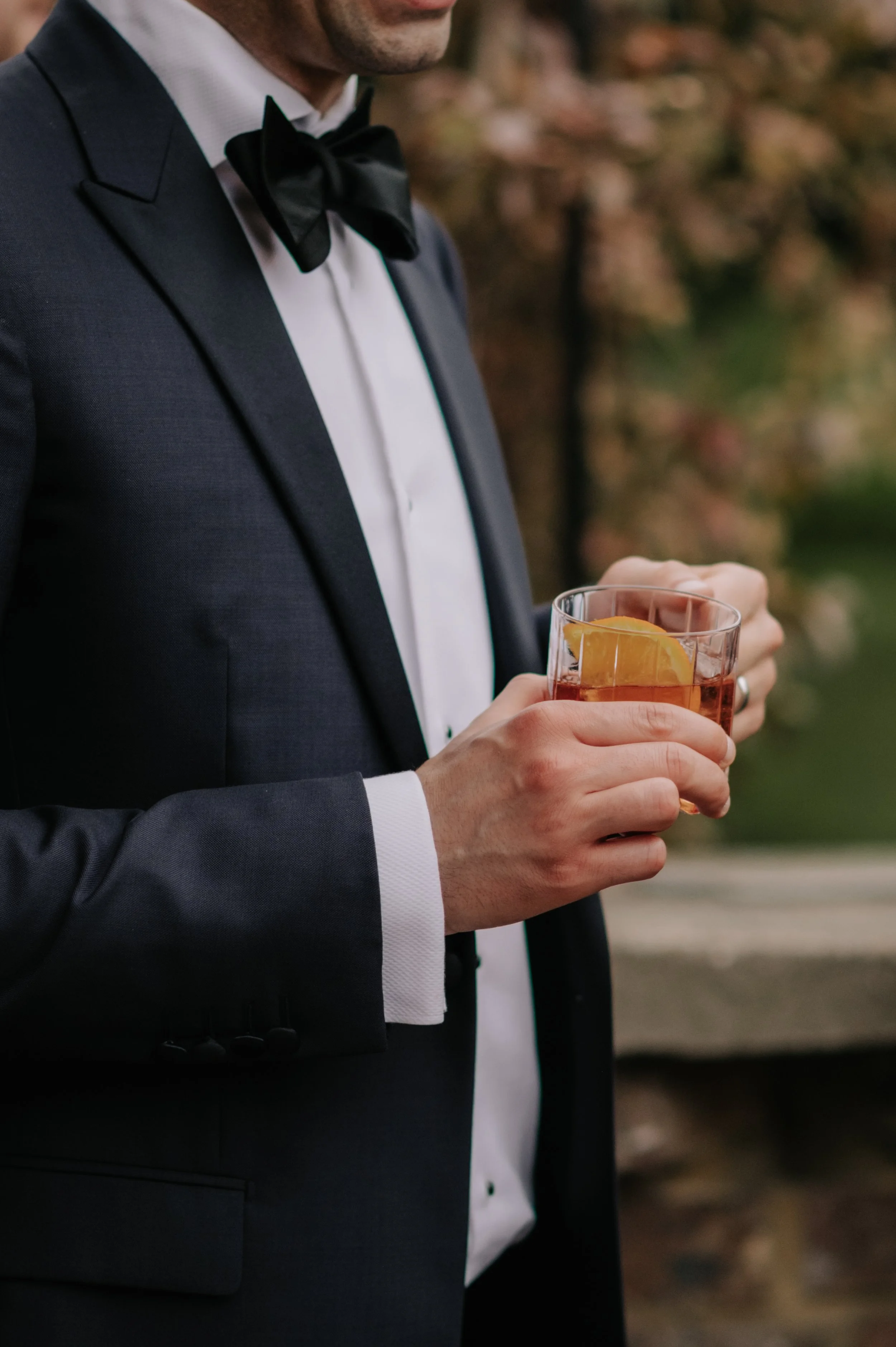 London wedding photography at Belvedere in Holland Park guest holding drink