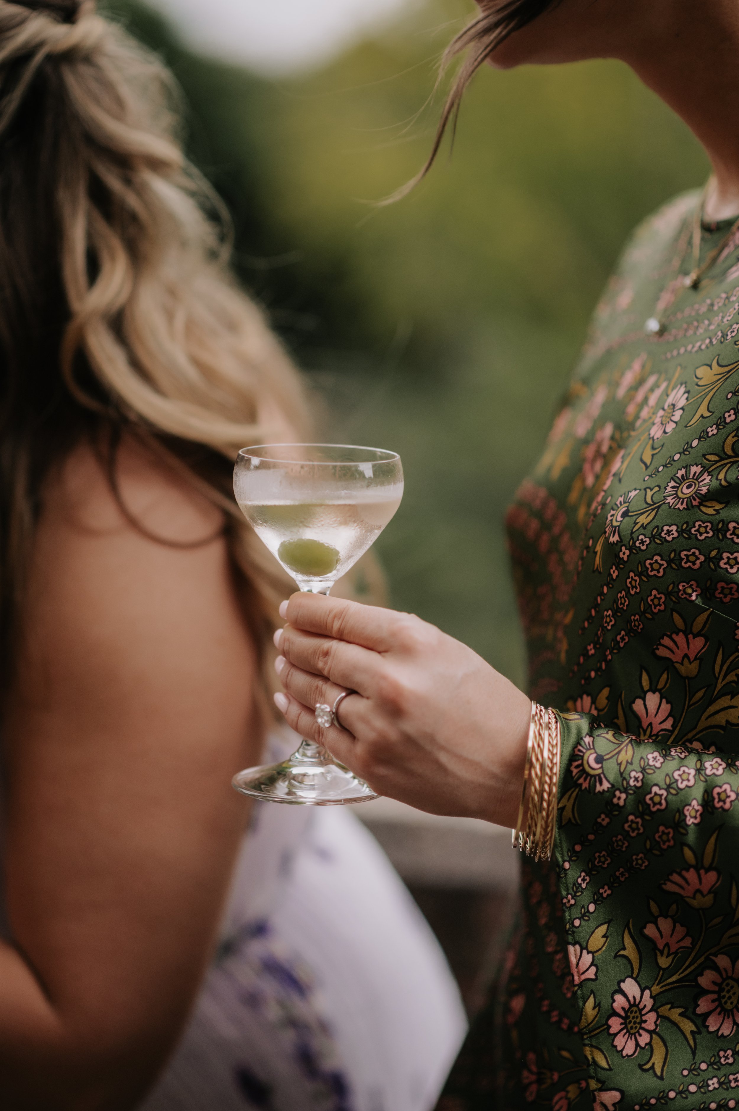 London wedding photography at Belvedere in Holland Park guest holding martini