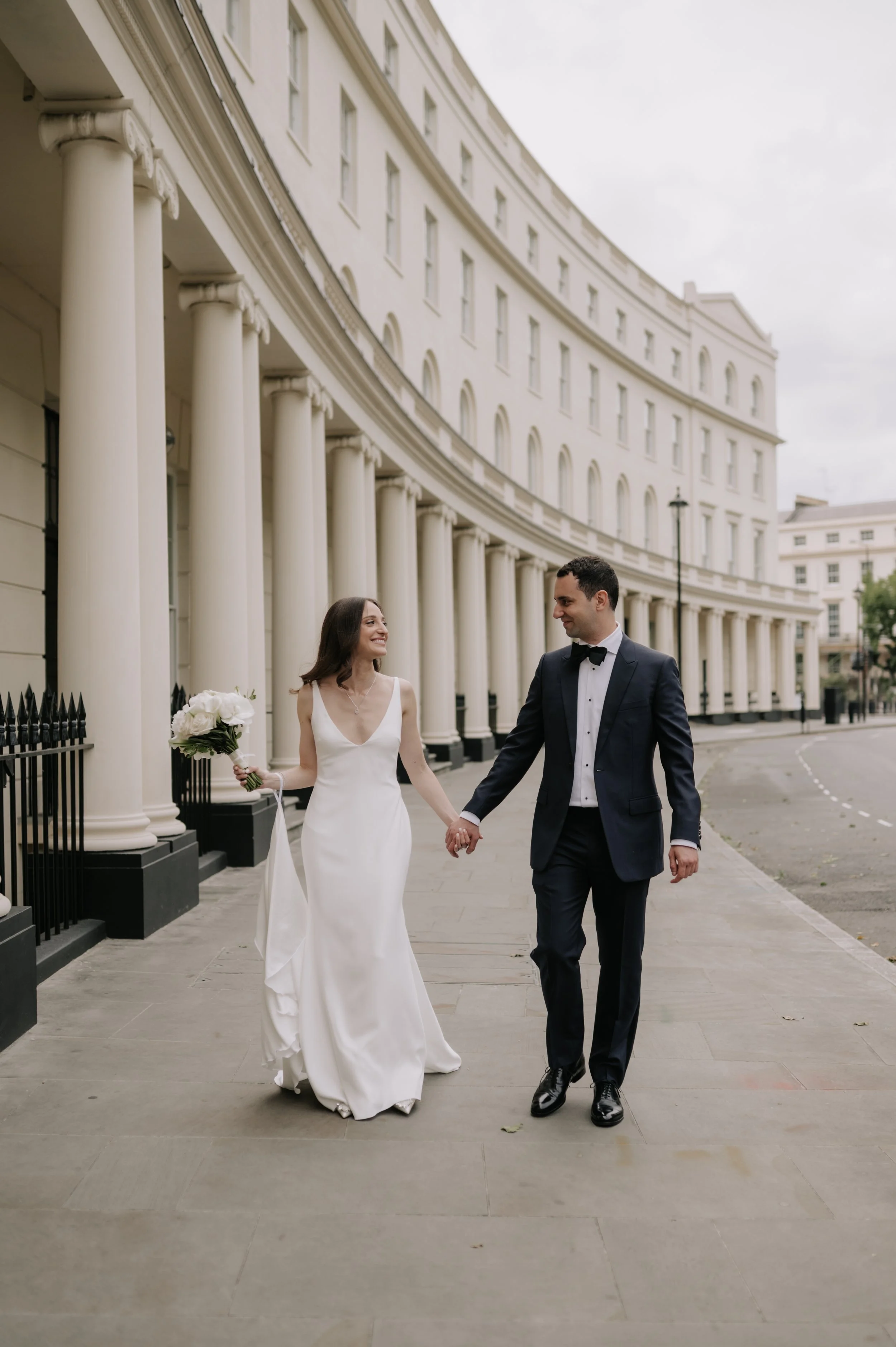 London wedding photography at Marylebone Town Hall bride and groom walking holding hands