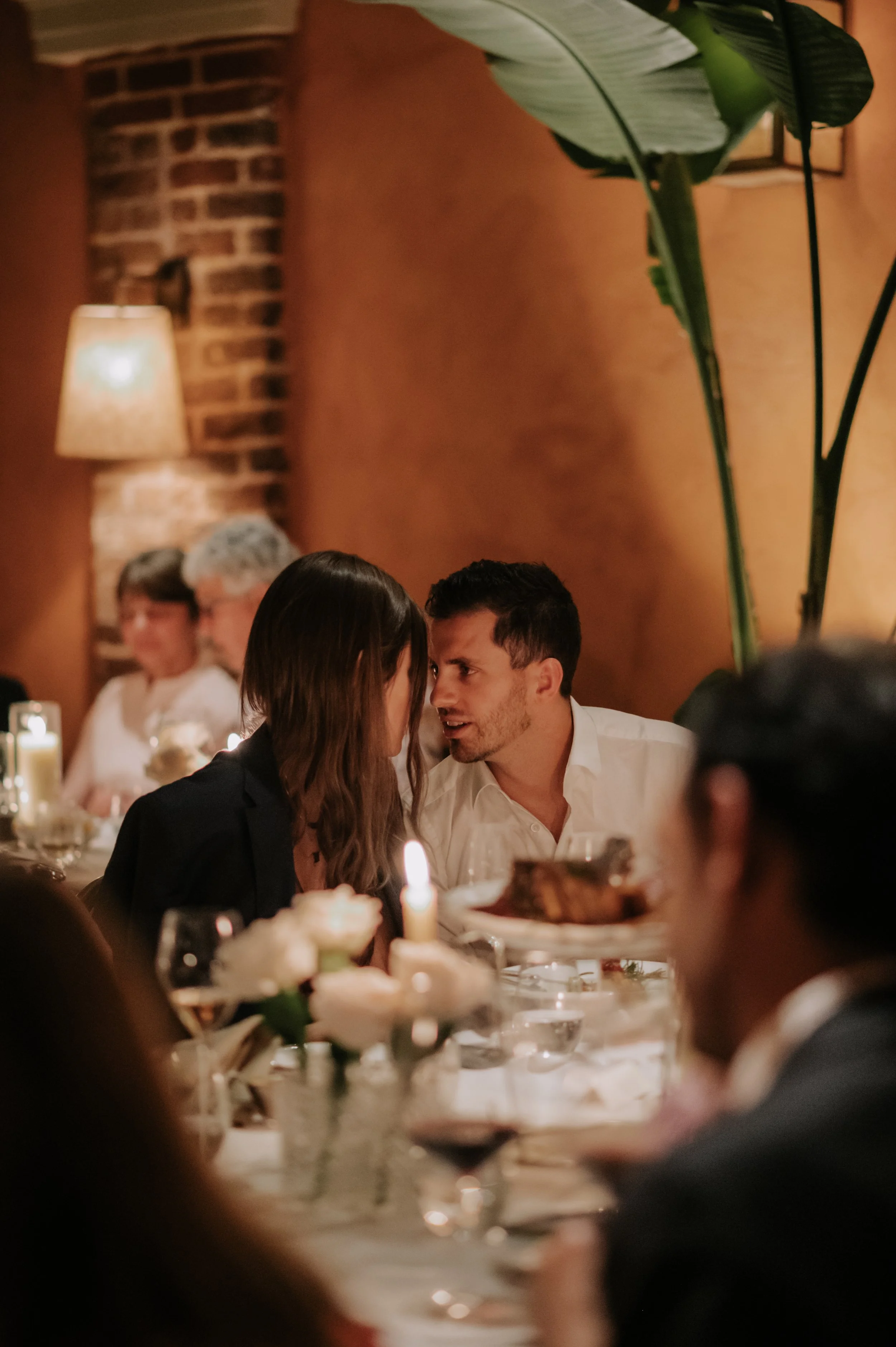 candlelit dinner London wedding photography at Belvedere in Holland Park guests looking at each other 
