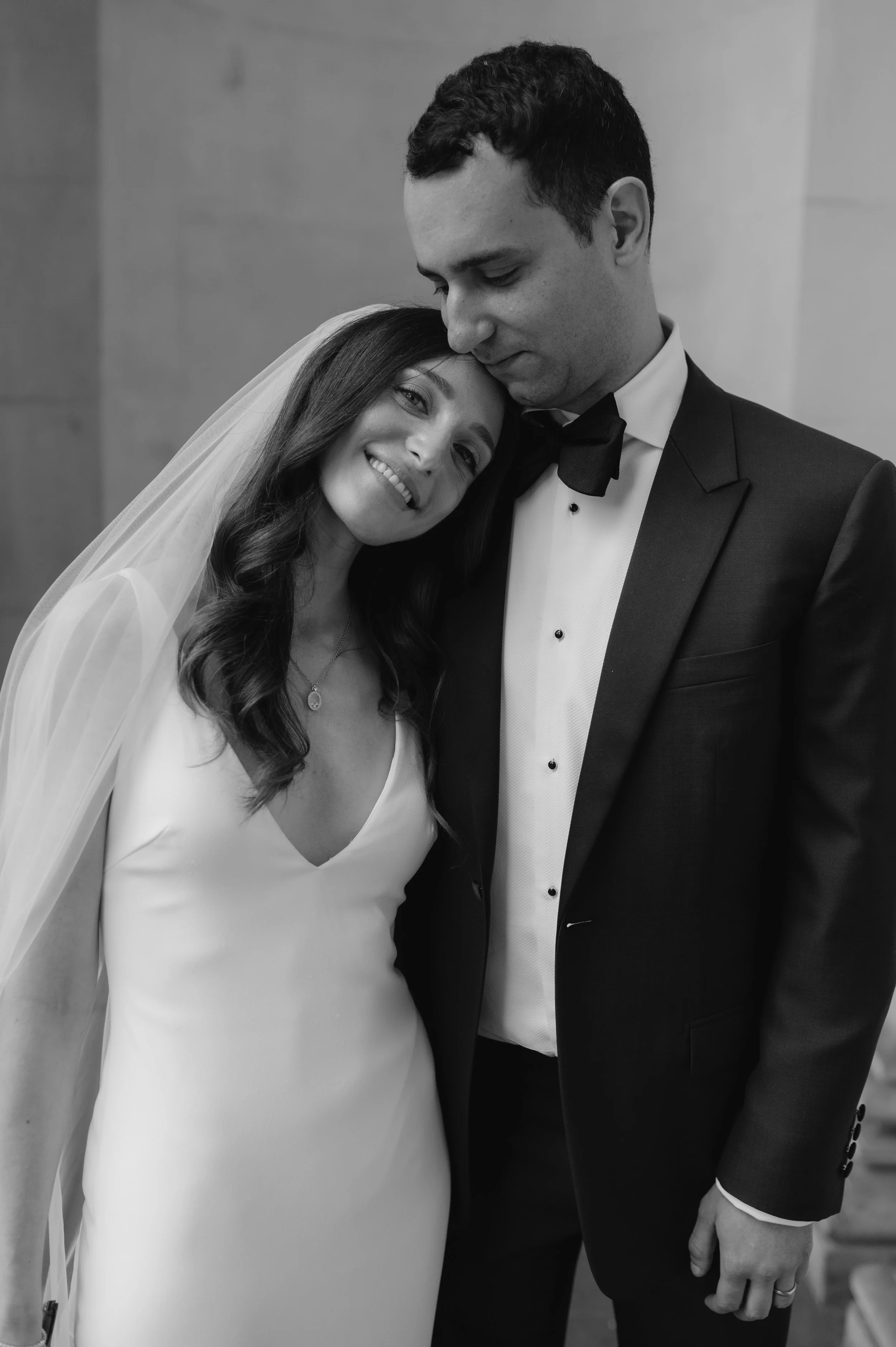 London wedding photography at Marylebone Town Hall bride resting head on grooms shoulder 