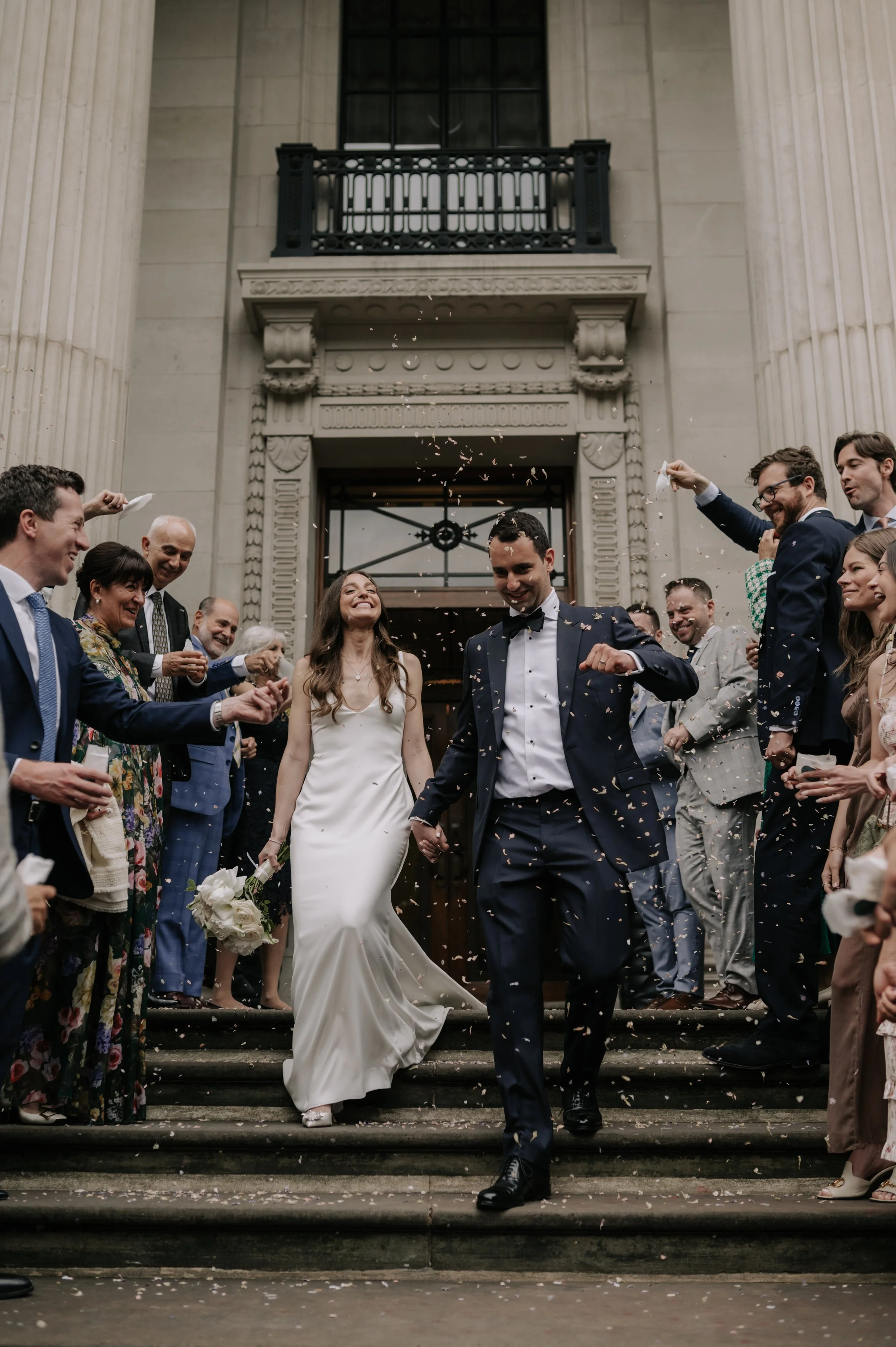 London wedding photography at Marylebone Town Hall bride and groom in confetti tunnel