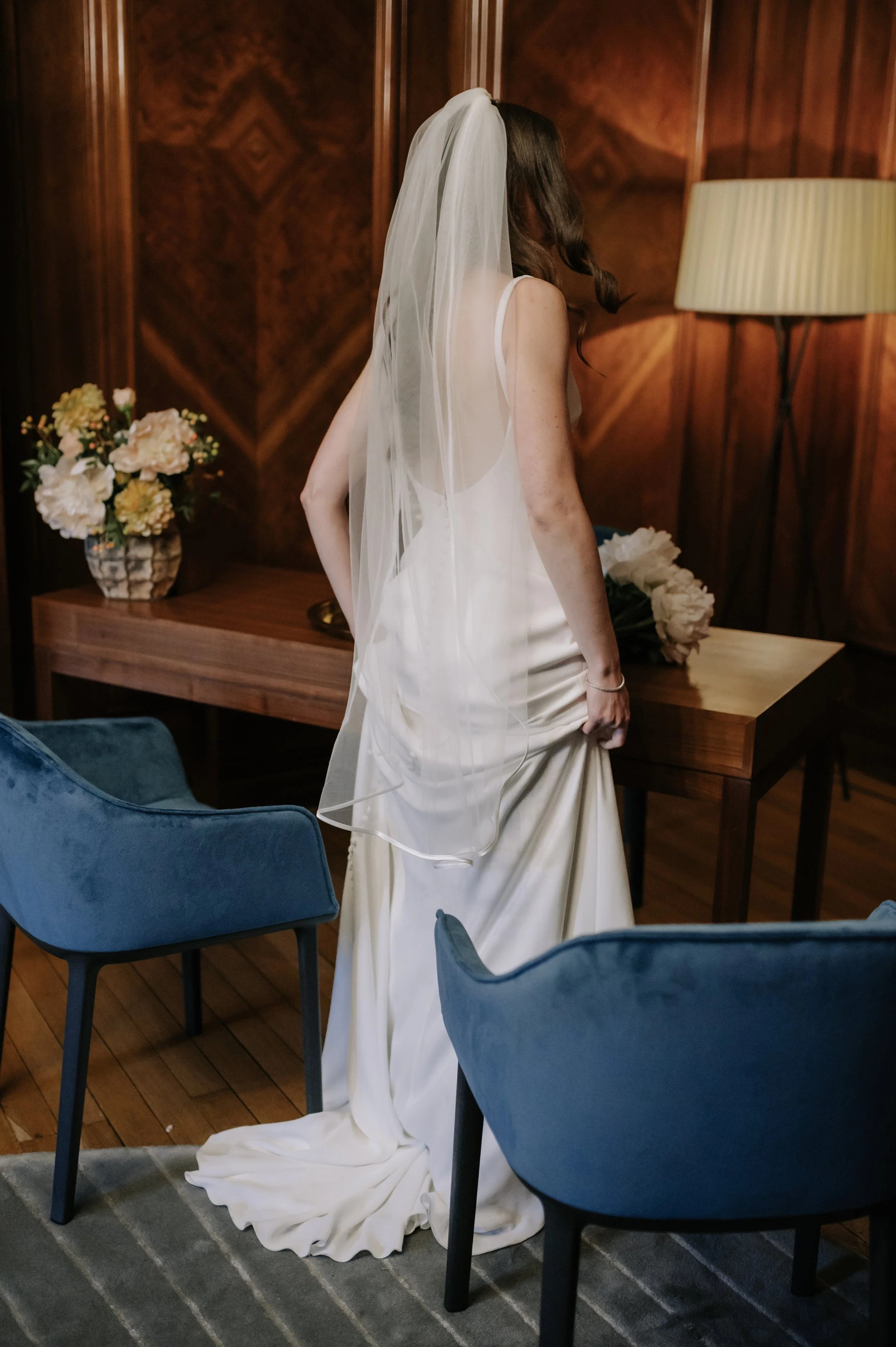 London wedding photography at Marylebone Town Hall bride lifting up dress