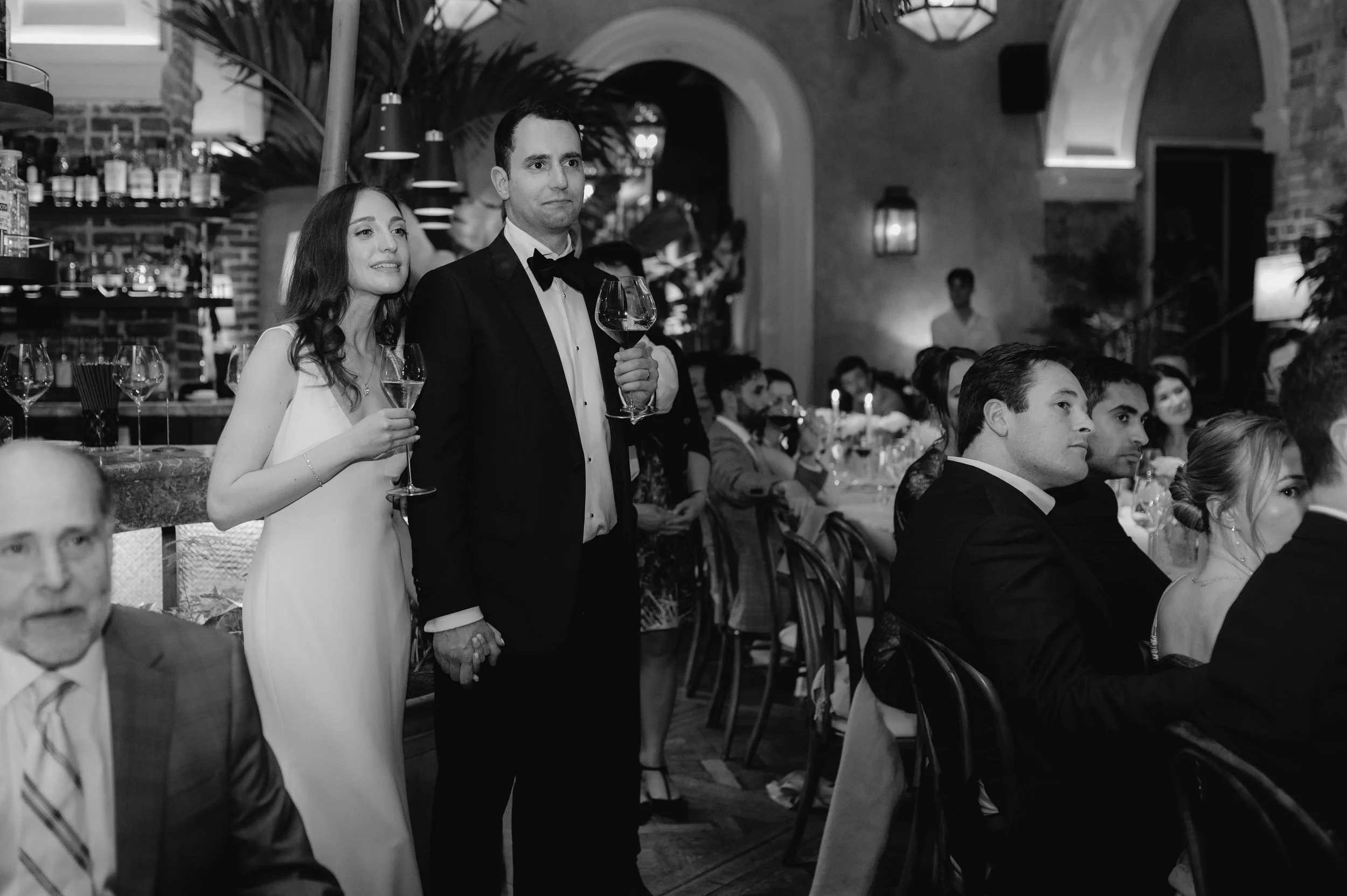 candlelit dinner London wedding photography at Belvedere in Holland Park bride and groom listening to speech 