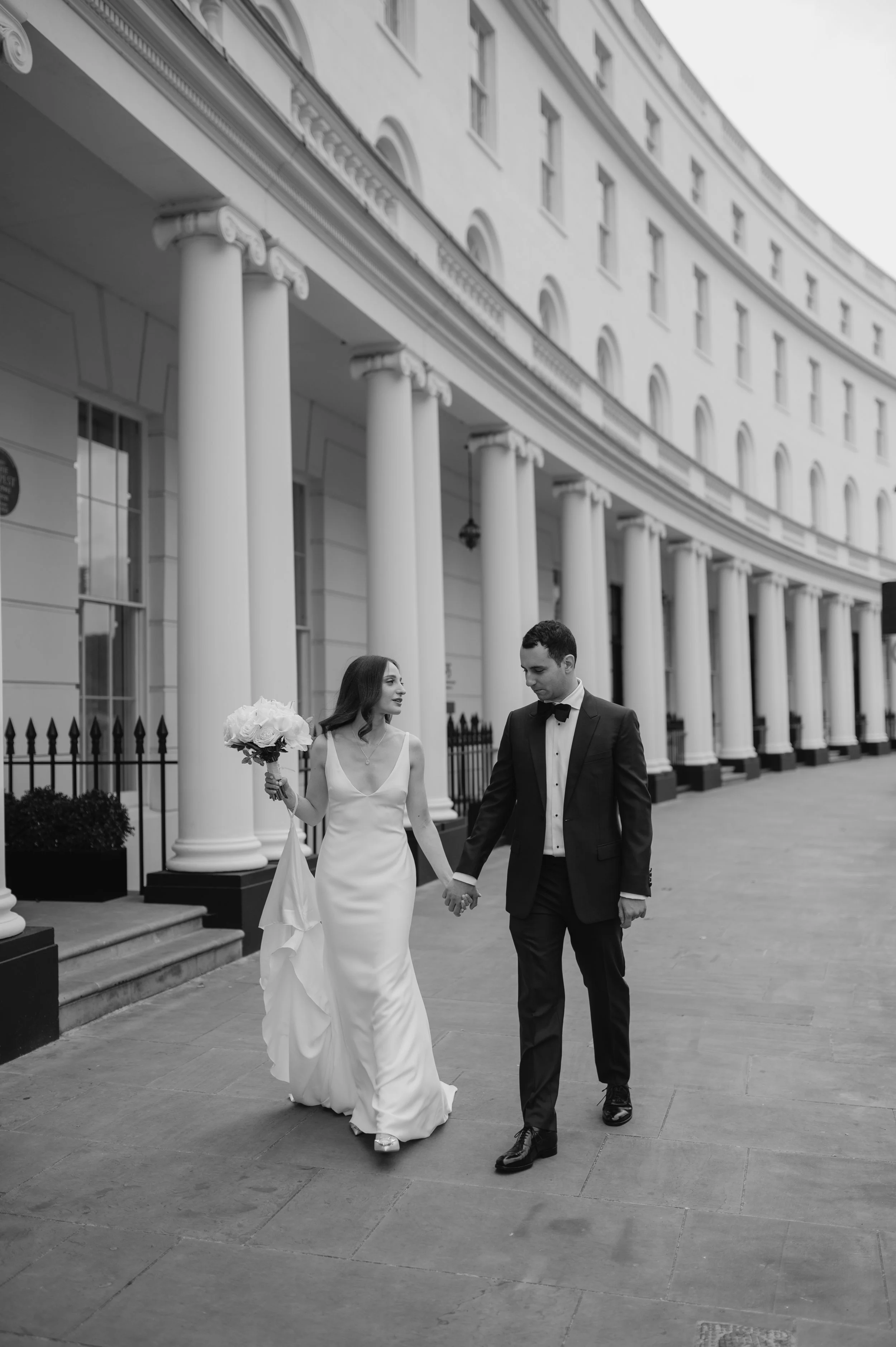 London wedding photography at Marylebone Town Hall bride and groom walking holding hands