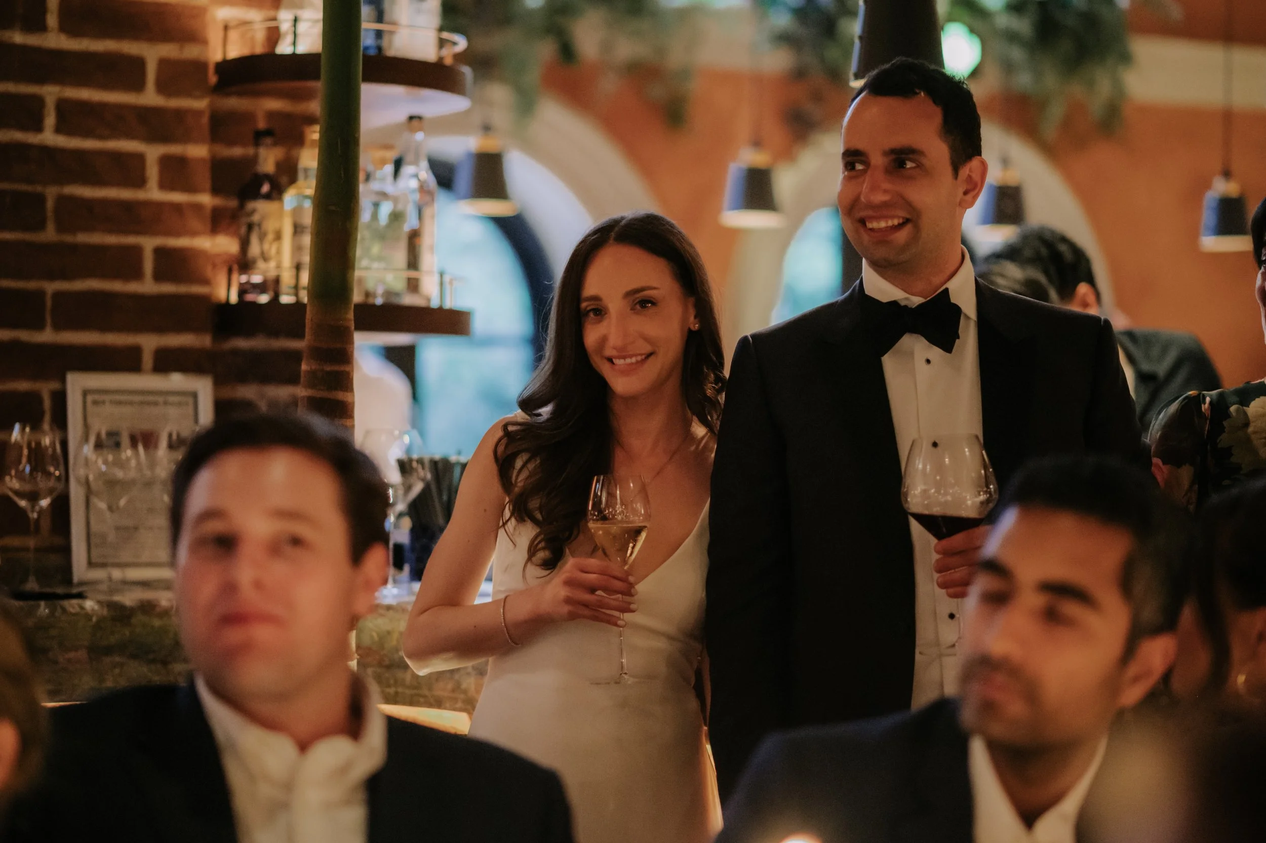 candlelit dinner London wedding photography at Belvedere in Holland Park bride and groom smiling during speech 