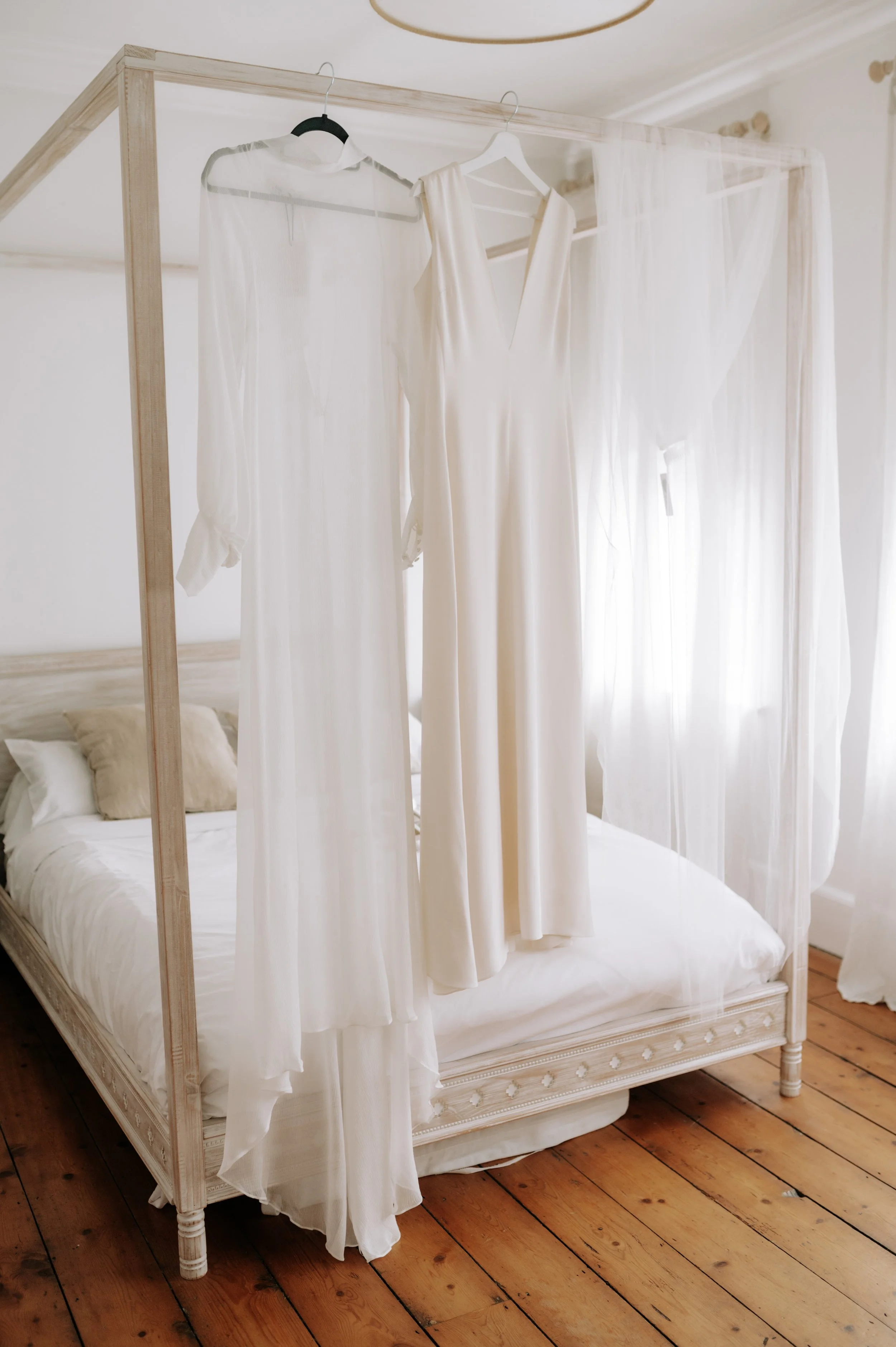 Wedding dress hanging at Brighton wedding. Fine art documentary wedding photography. 