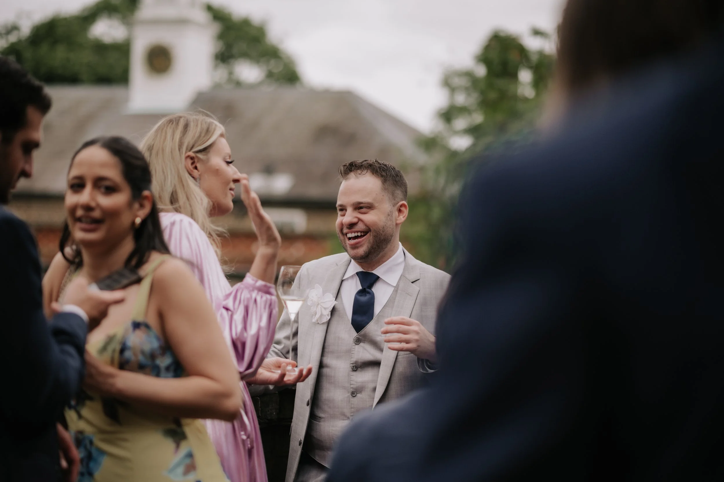 London wedding photography at Belvedere in Holland Park guest laughing