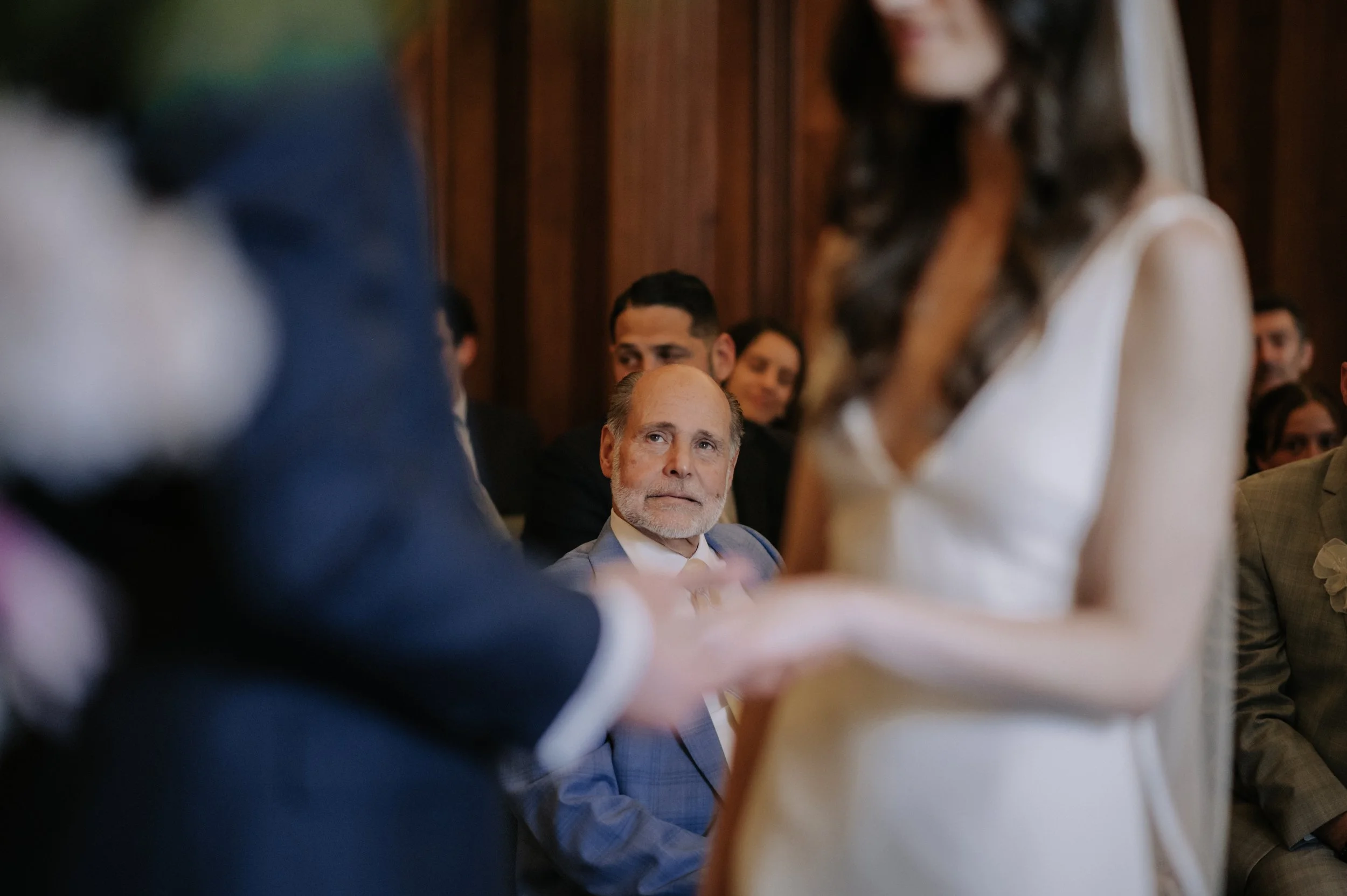 London wedding photography at Marylebone Town Hall bride's dad smiling at bride and groom 