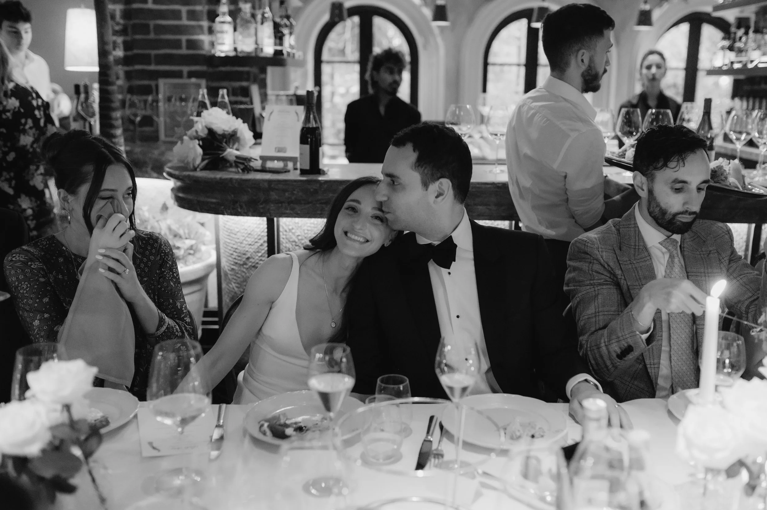 candlelit dinner London wedding photography at Belvedere in Holland Park bride smiling at camera and leaning into groom 
