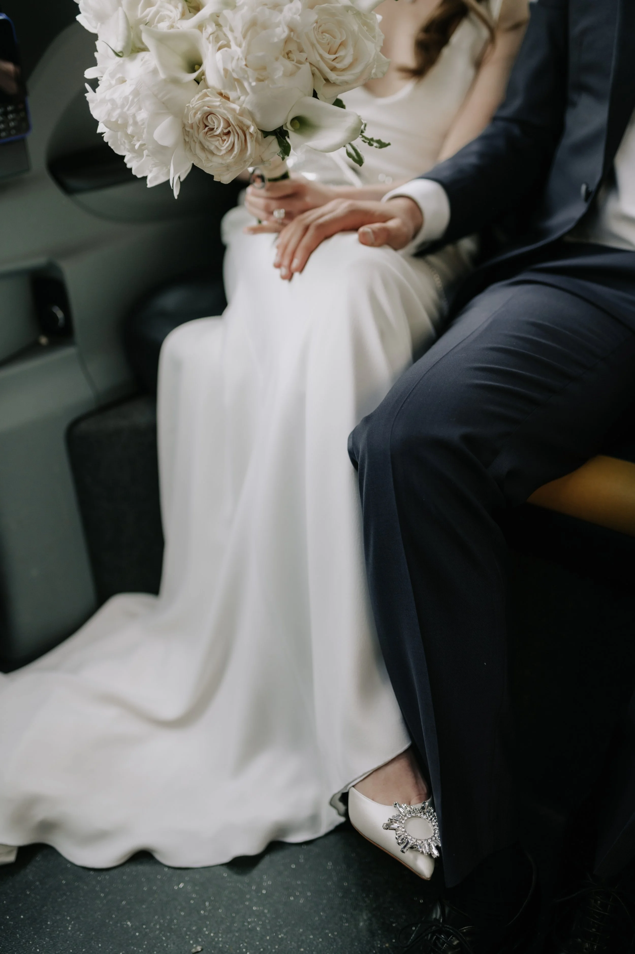 London wedding photography at Marylebone Town Hall groom placed hand on brides leg in taxi