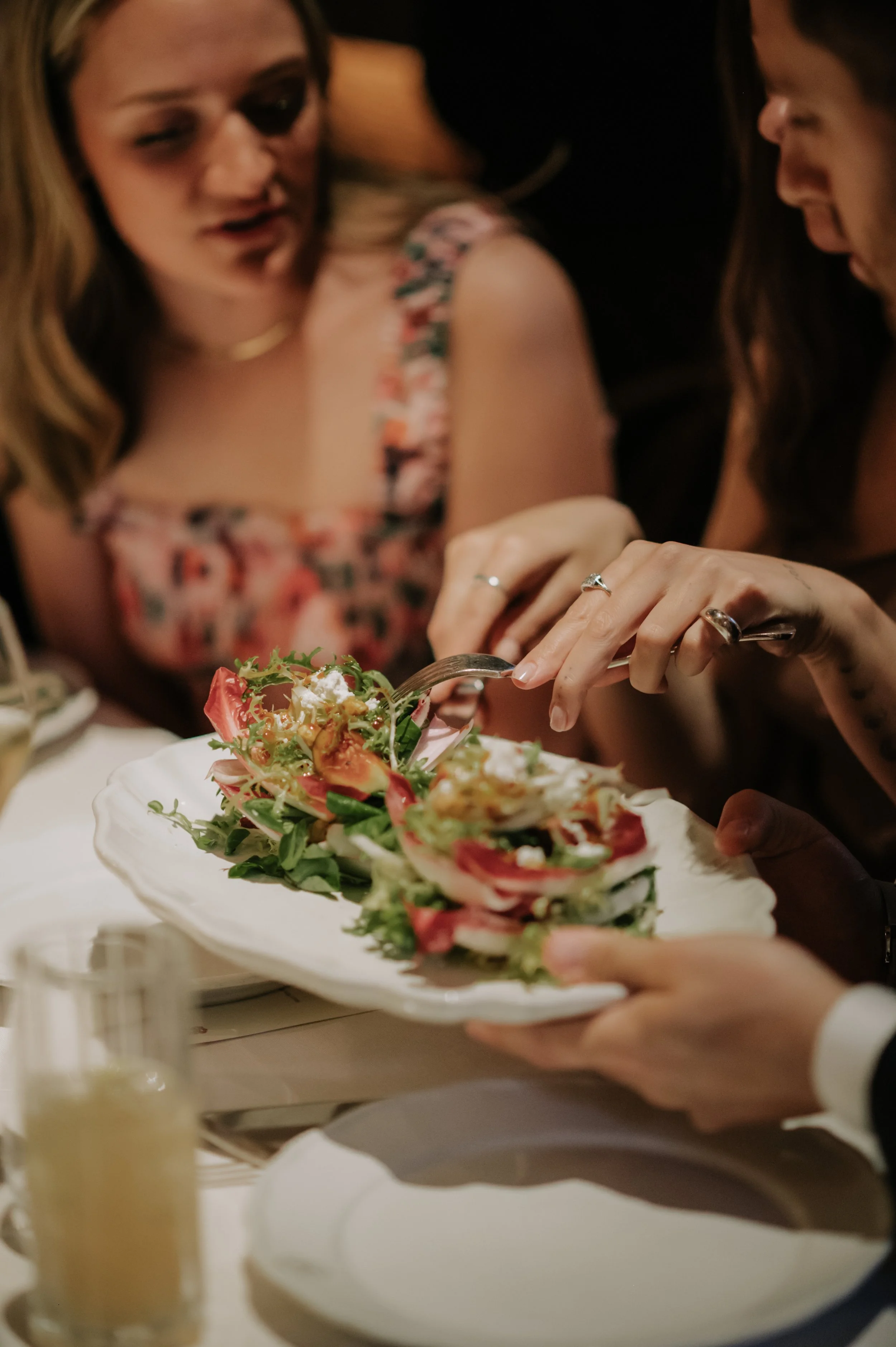 candlelit dinner London wedding photography at Belvedere in Holland Park guest taking food off plate 